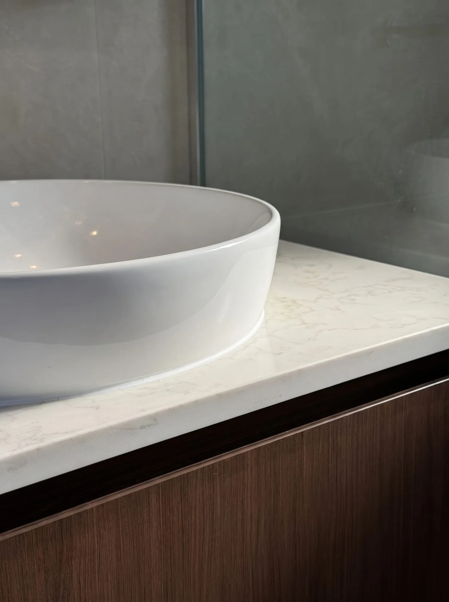 White vessel basin on a stone benchtop above walnut joinery, Churchouse Road Greenhithe