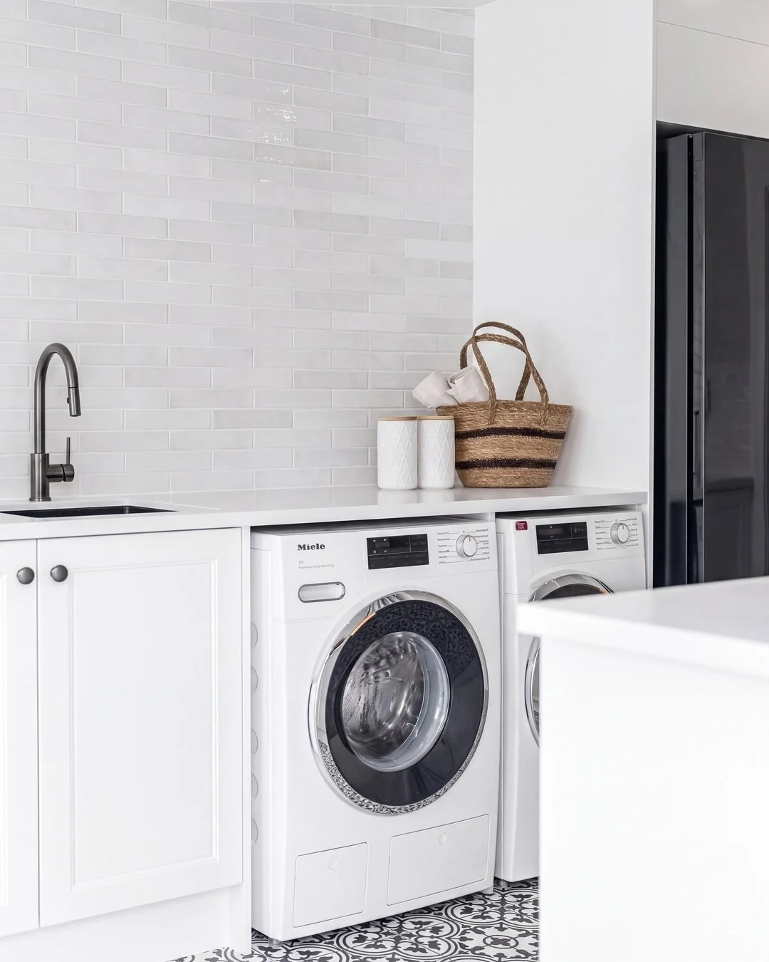 Washer and dryer side by side under the stone benchtop in the St Marys Bay laundry