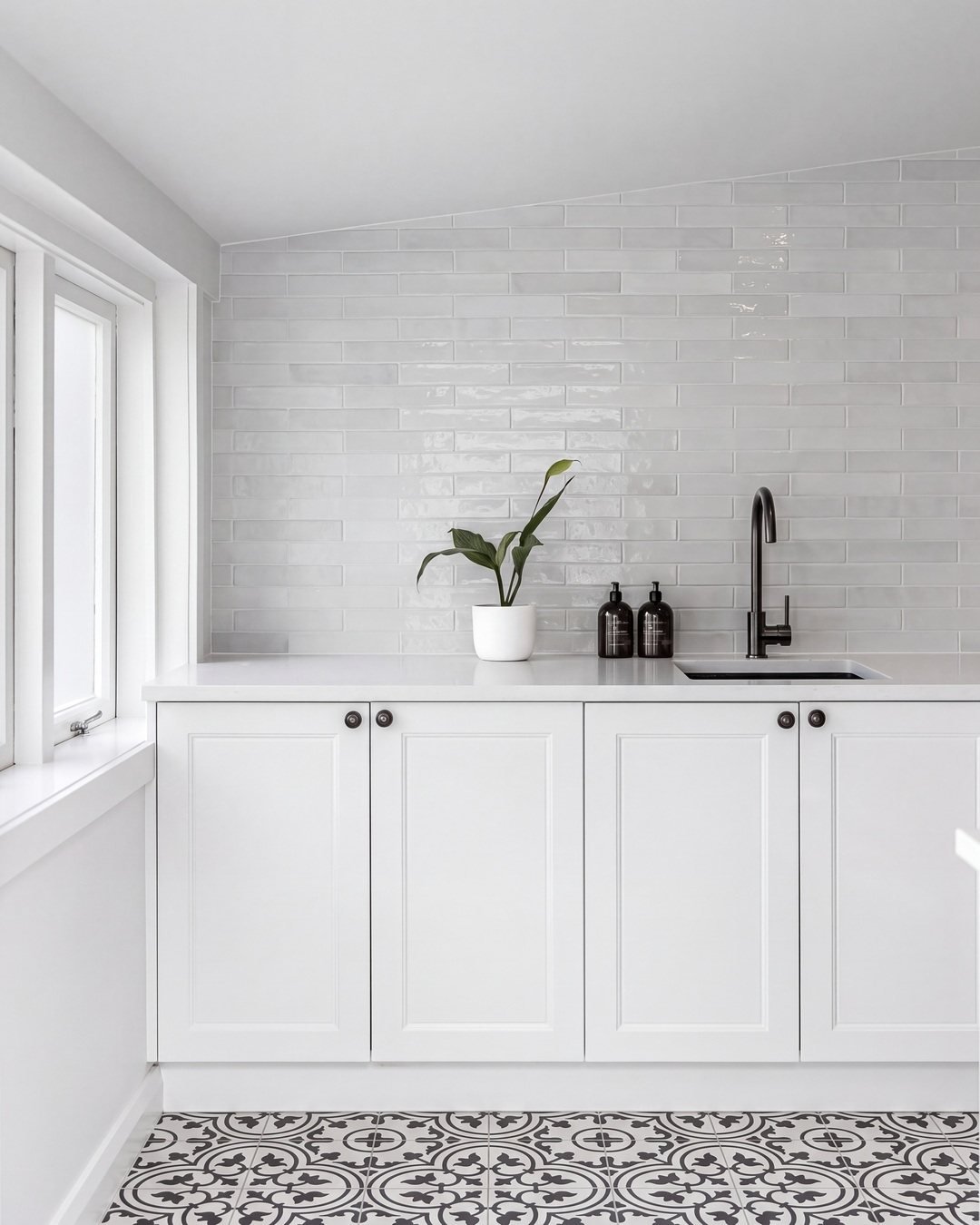 White shaker laundry cabinetry and stone benchtop at the end wall, St Marys Bay