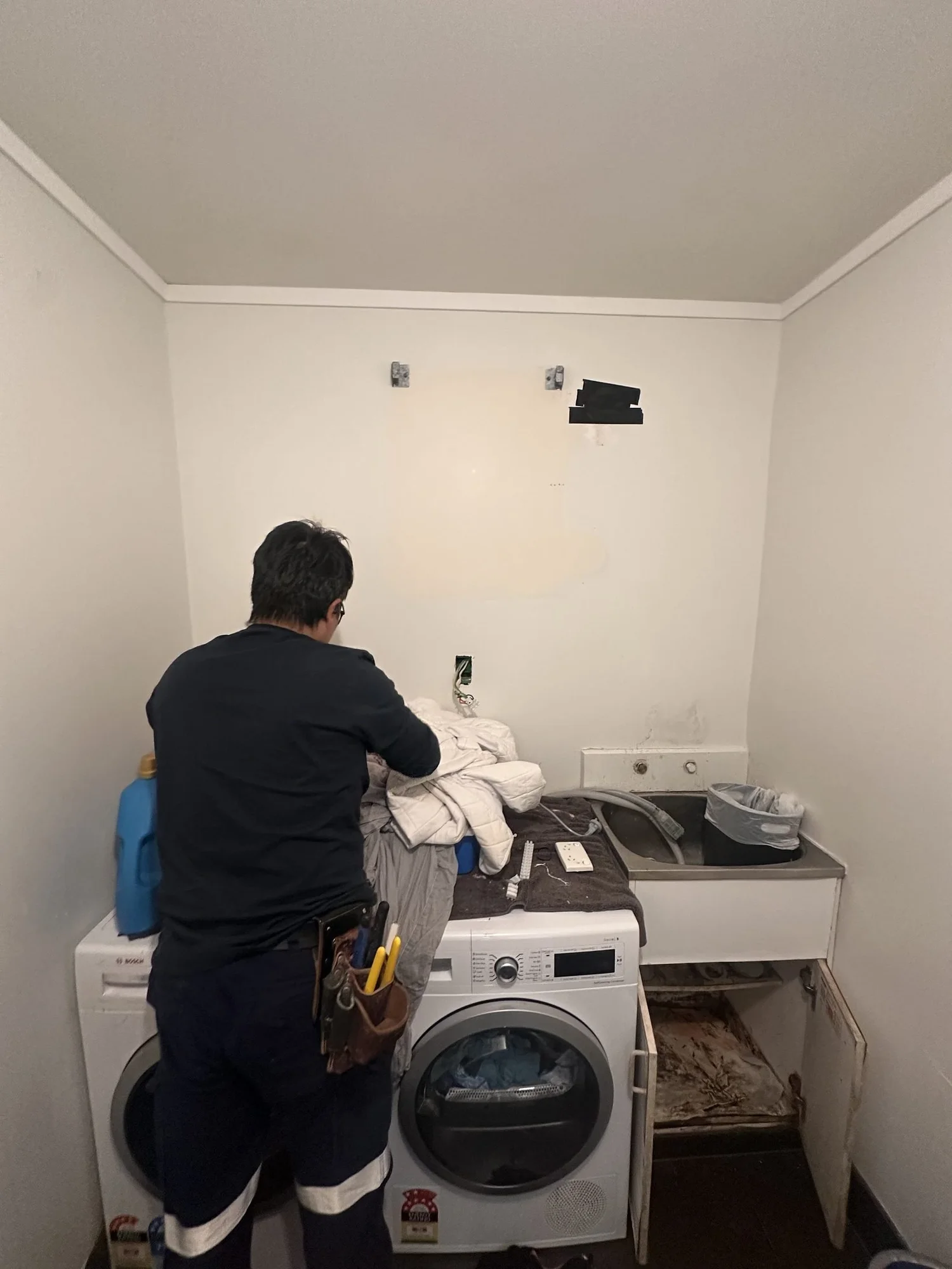 Strip-out day one on the Rarangi Road laundry, wall cupboard coming off, St Heliers