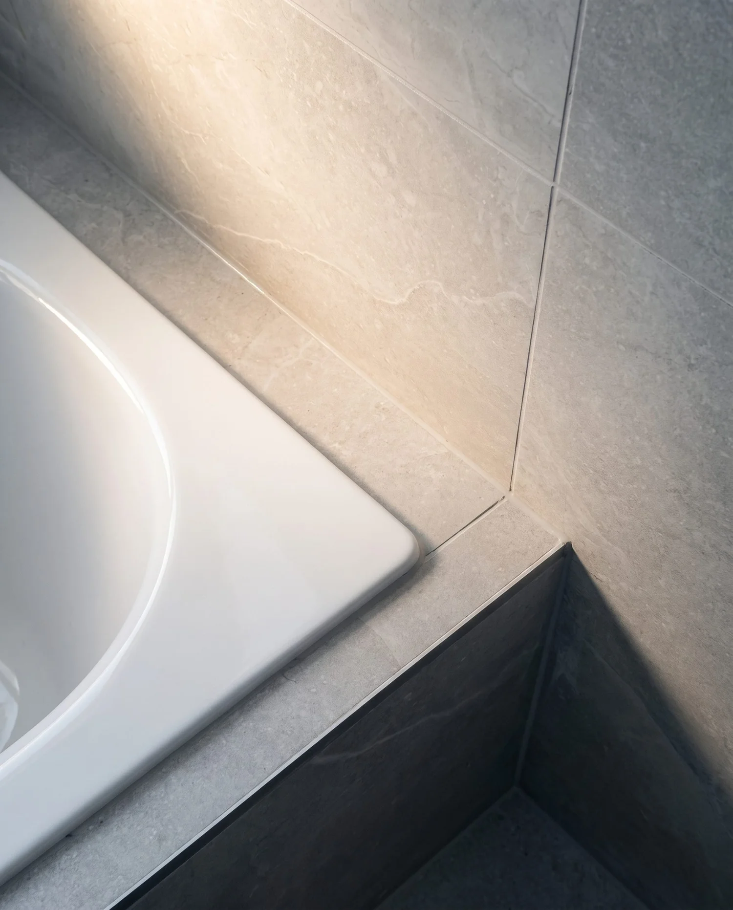 Bath edge meeting large-format porcelain in the Churchouse Road family bathroom, Greenhithe