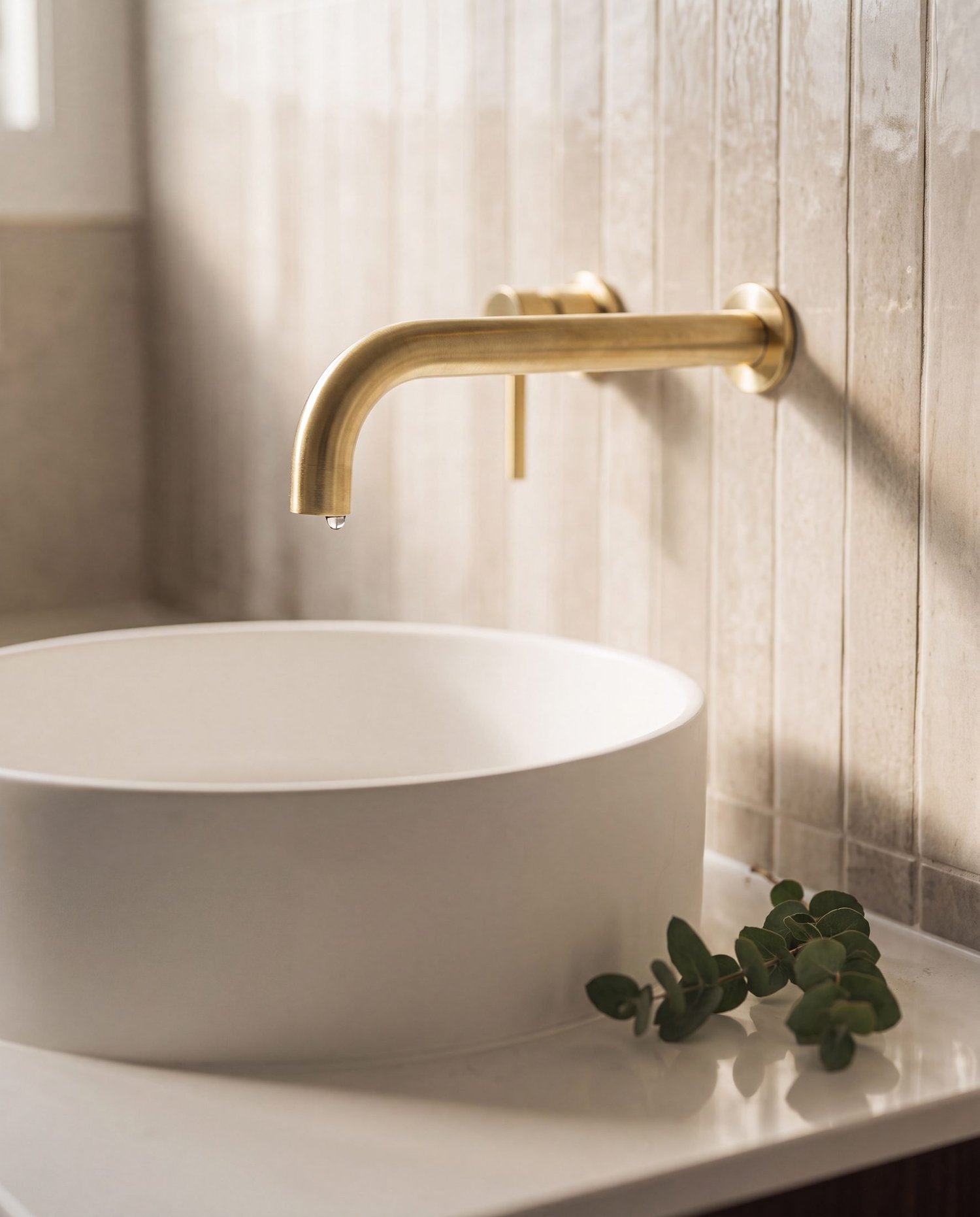 Brushed brass wall-mounted spout over a round white vessel basin, Parnell bathroom renovation