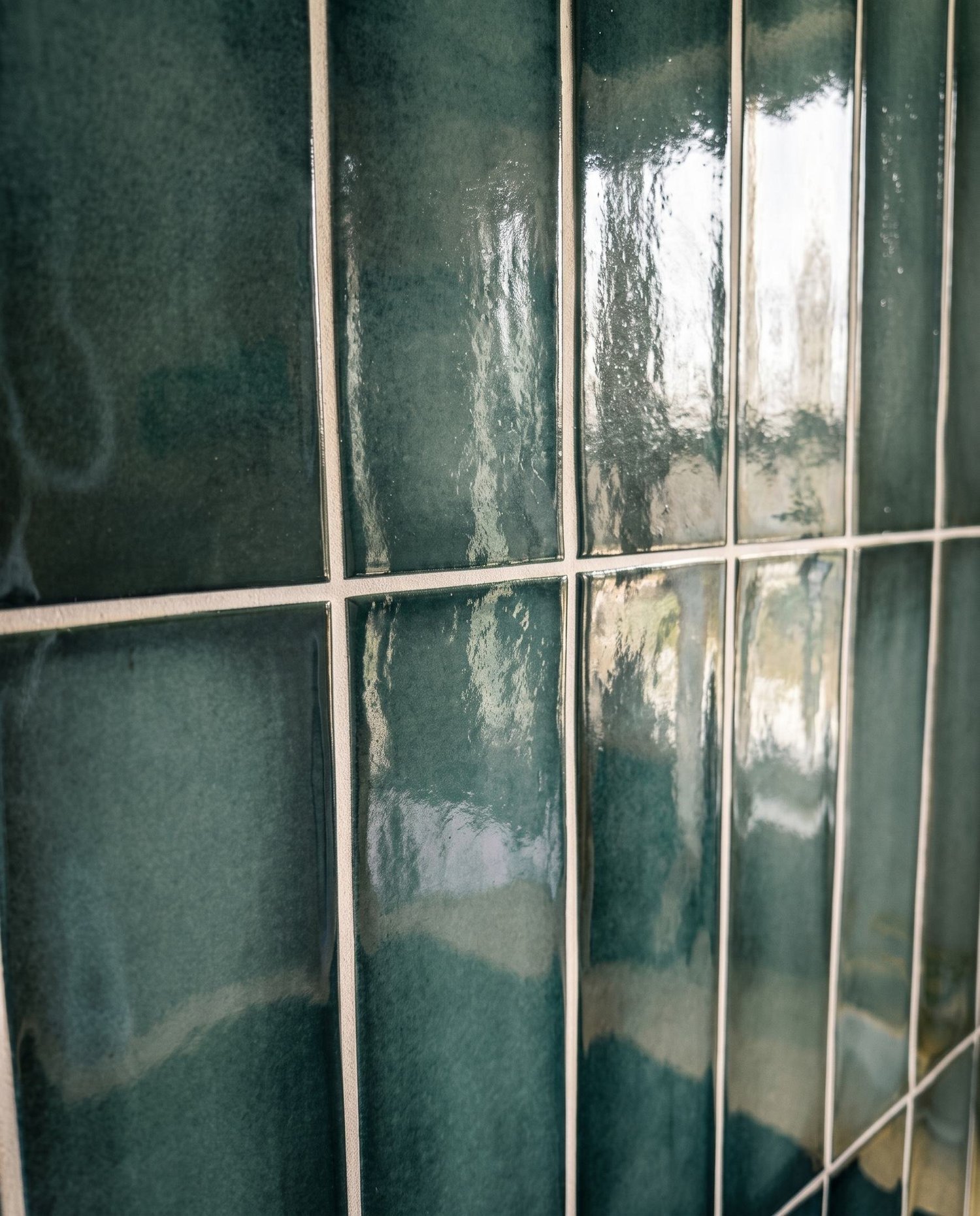 Dark green vertical stack-bond gloss tile detail in the Merani Street kitchen, Belmont