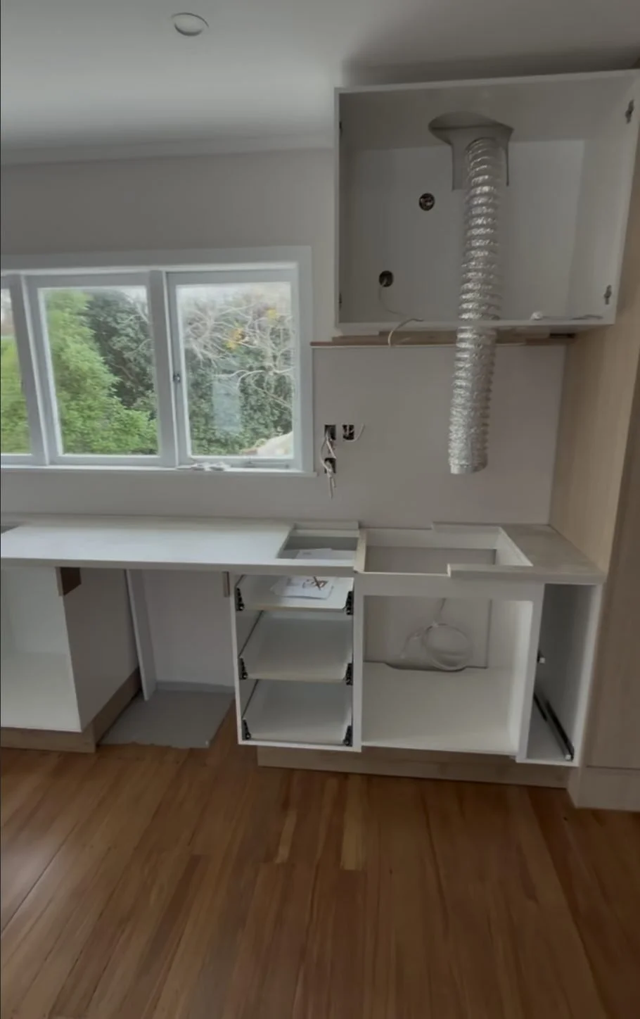 Rangehood extraction ducting dropping through the ceiling into the cabinetry, Belmont kitchen