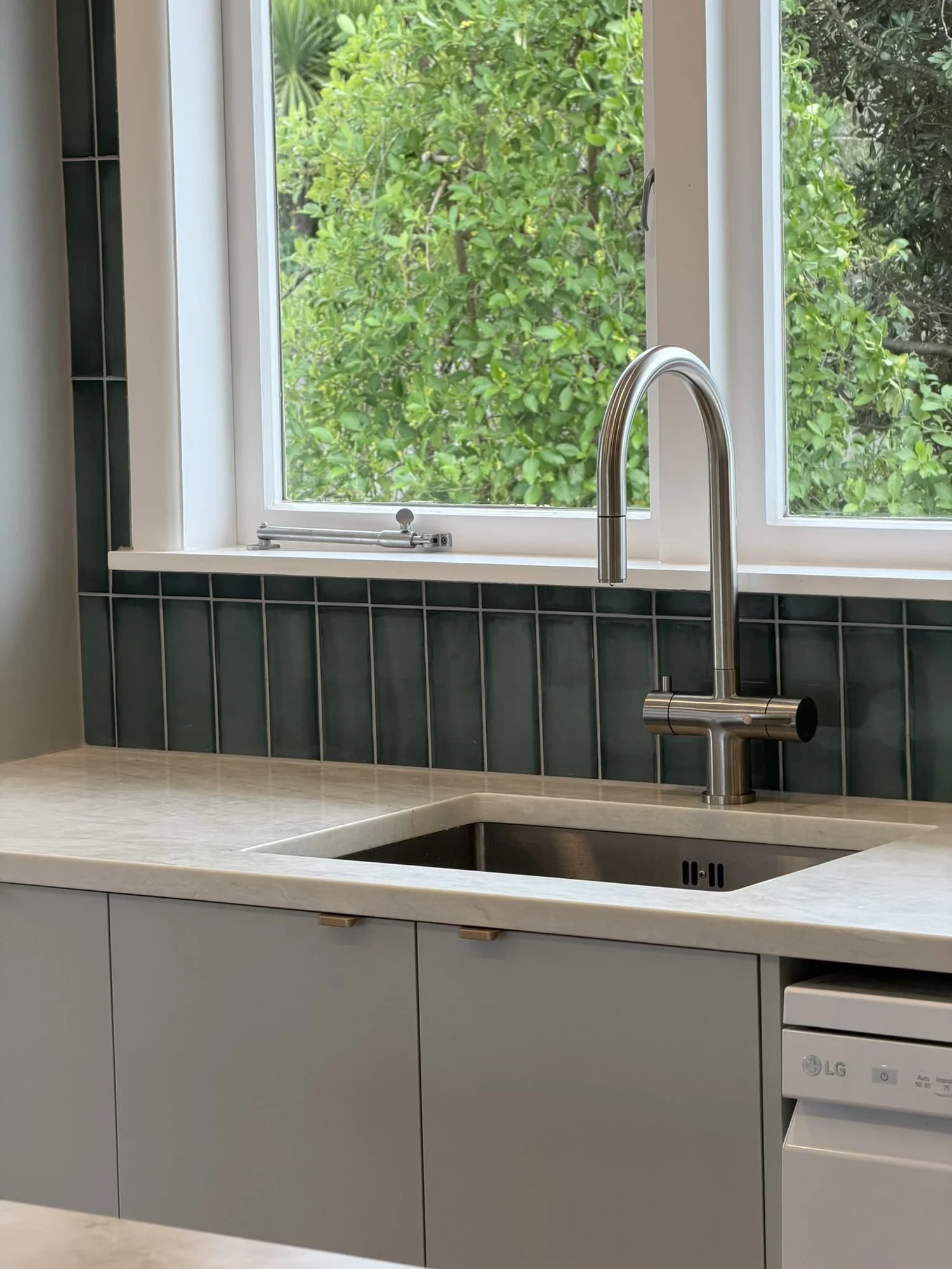 Undermount sink, window and dark green stack-bond splashback, Merani Street kitchen Belmont