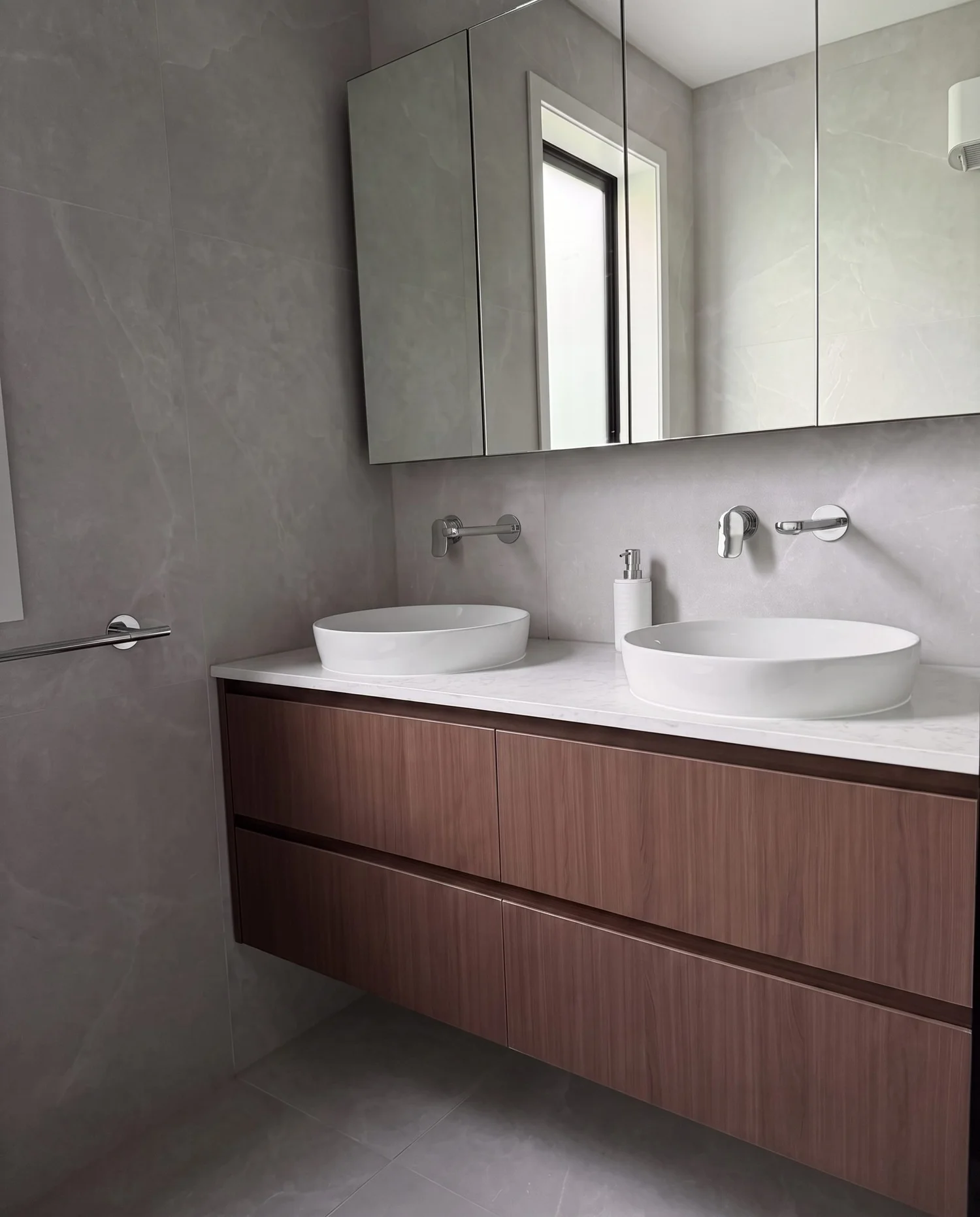Double vanity with wall-mounted chrome mixers and window in the Greenhithe master bathroom renovation