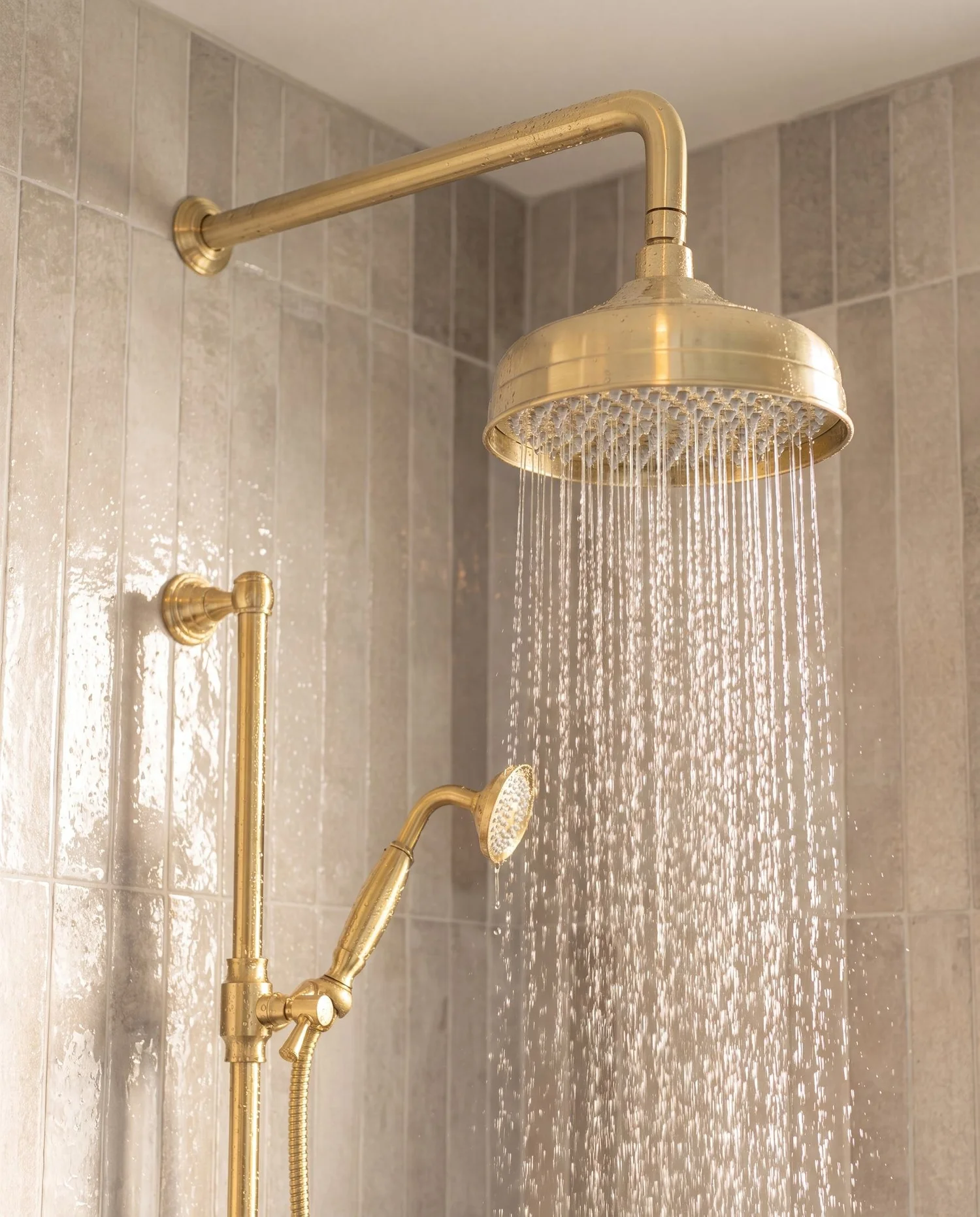 Brushed brass rainfall shower head and handheld on a brass rail, Parnell bathroom
