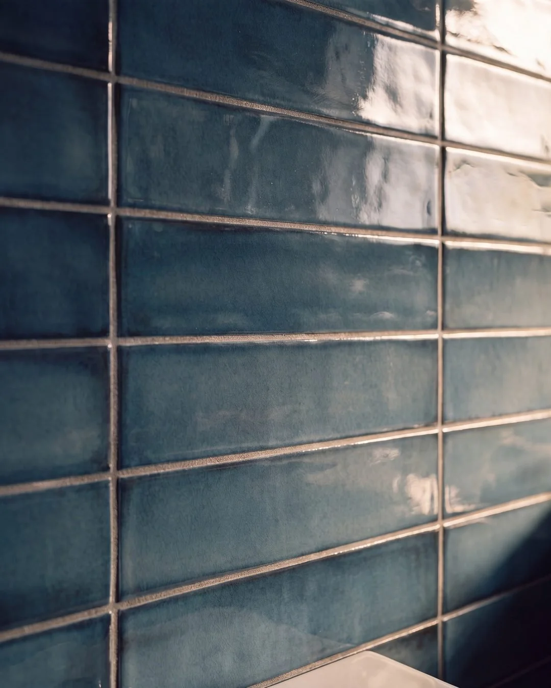 Deep blue gloss handmade-look tile detail in the Patterson Street ensuite, Sandringham