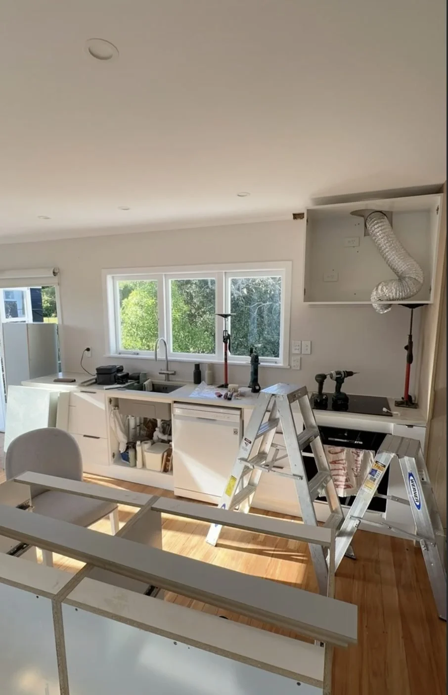 Kitchen window fully masked and prepped for painting during the Merani Street renovation