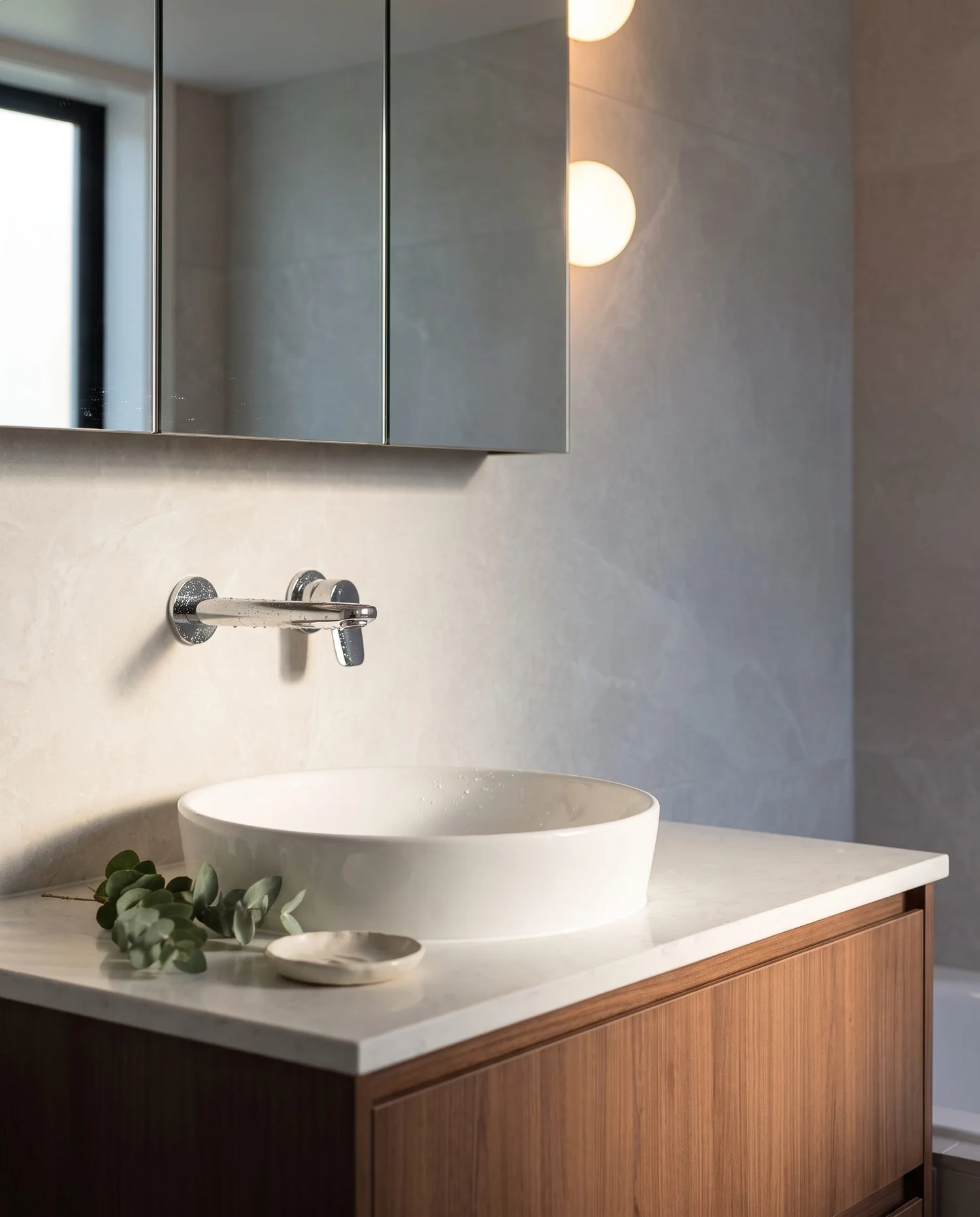 Wall-mounted chrome mixer above a round vessel basin on a stone benchtop, Churchouse Road Greenhithe