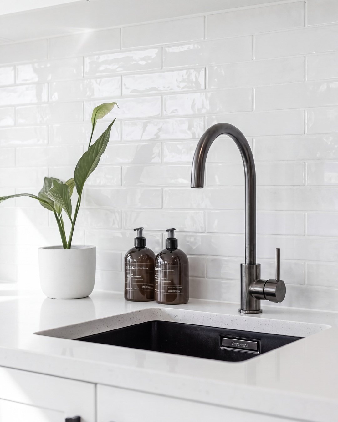 Gunmetal gooseneck mixer and black undermount sink in the Seymour Street laundry, St Marys Bay