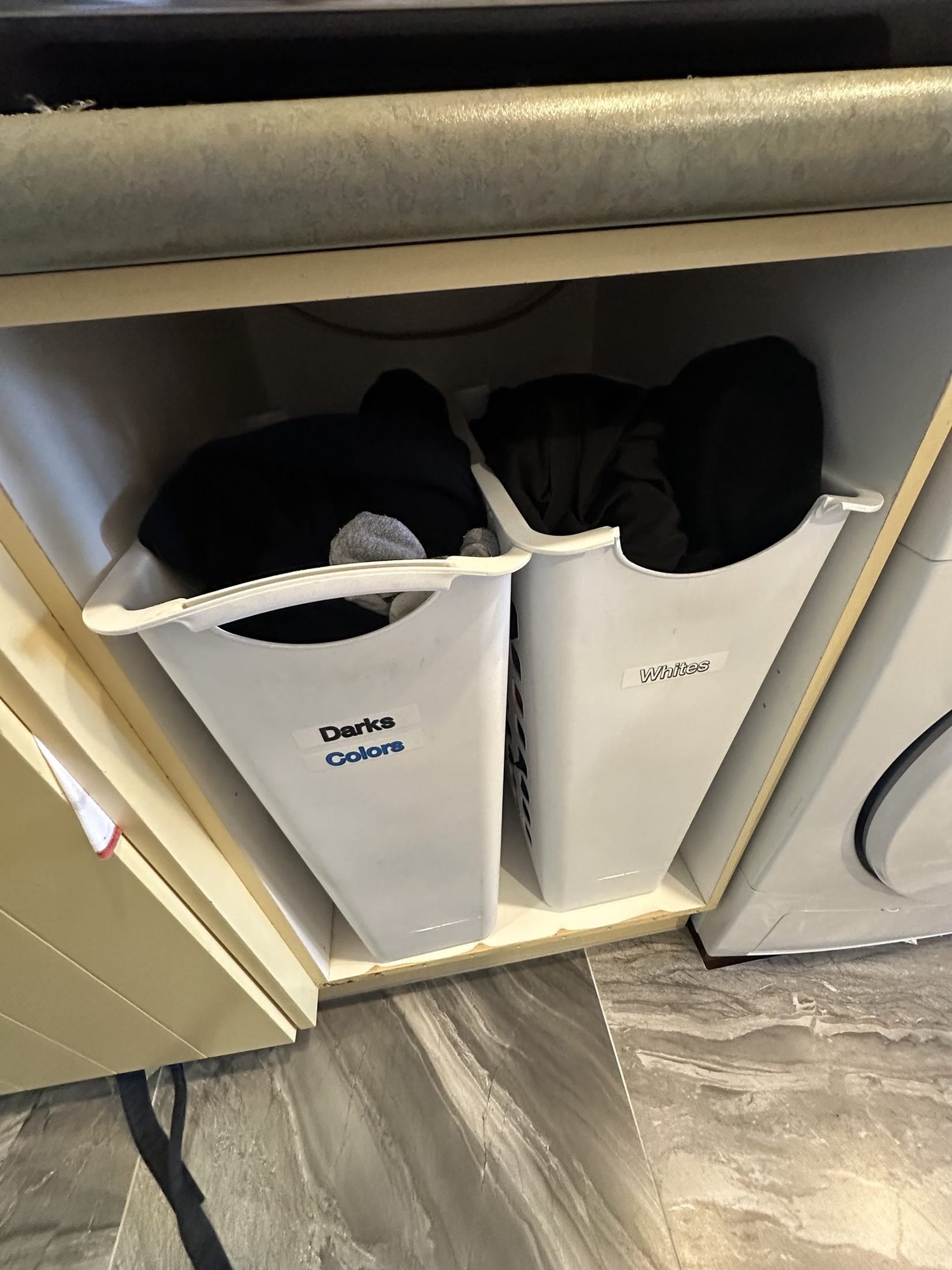 Old plastic pull-out laundry hampers before the Bayswater laundry renovation