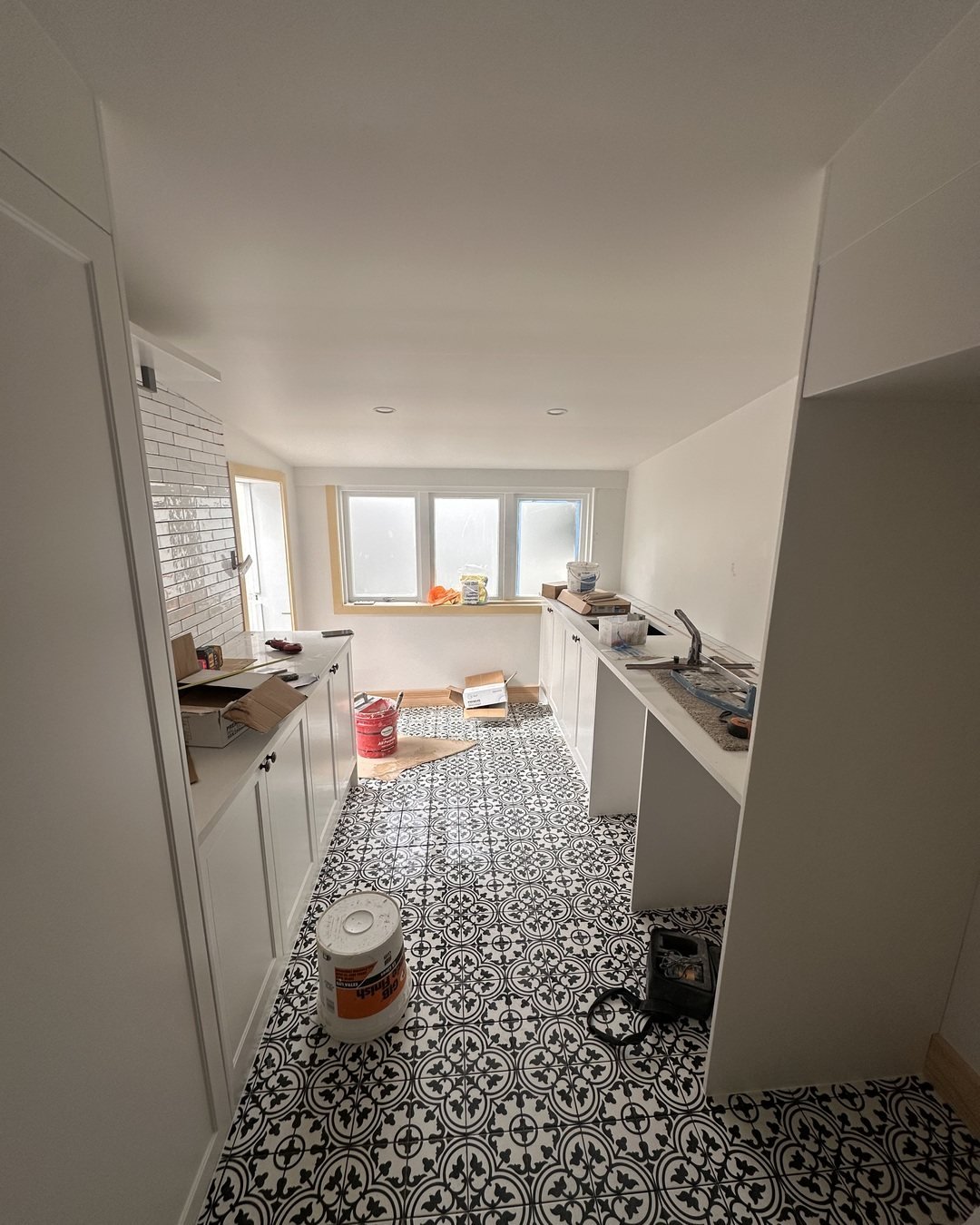 White shaker cabinetry being installed in the Seymour Street galley laundry, St Marys Bay