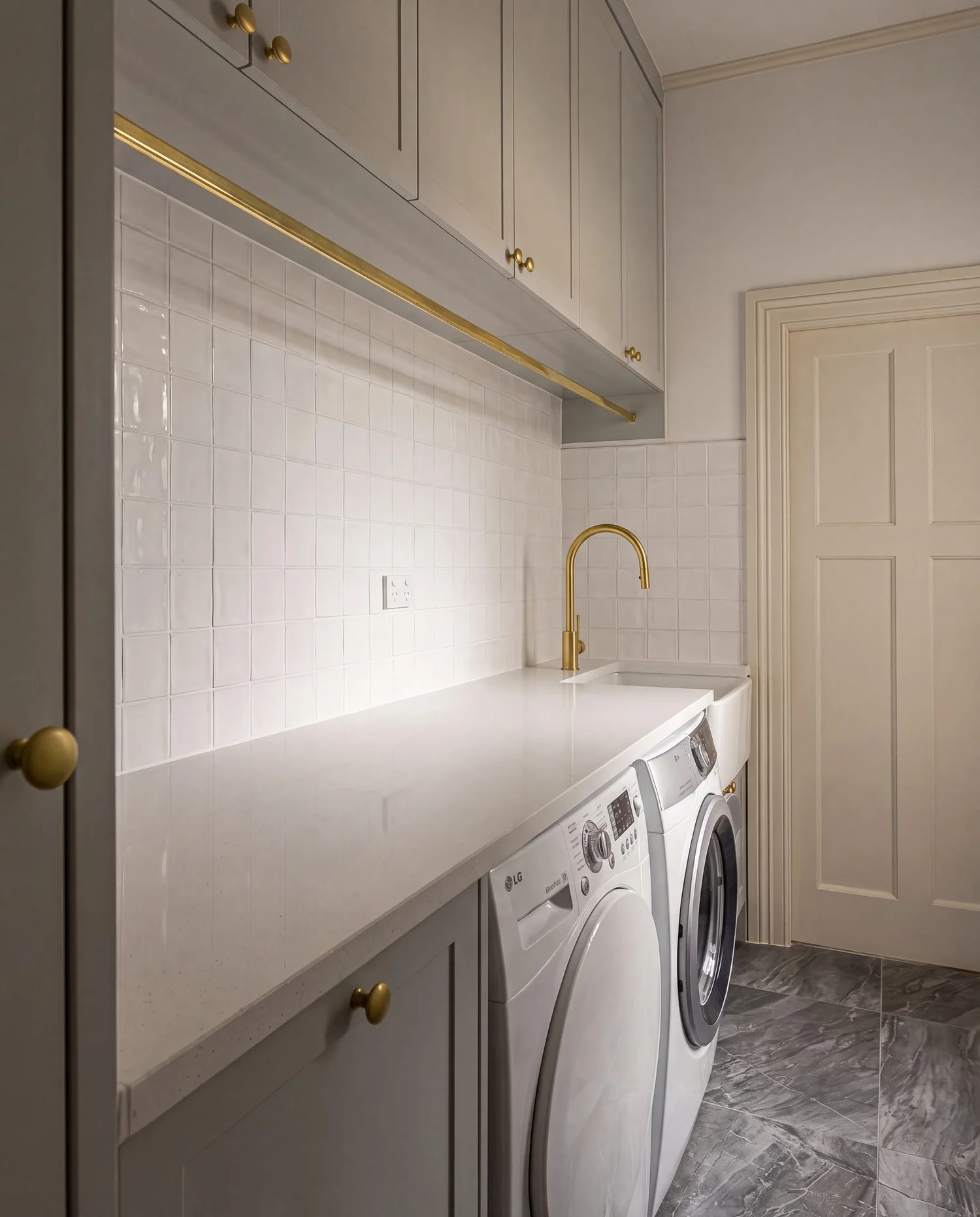 Full length speckled white stone benchtop running the length of the Bayswater laundry