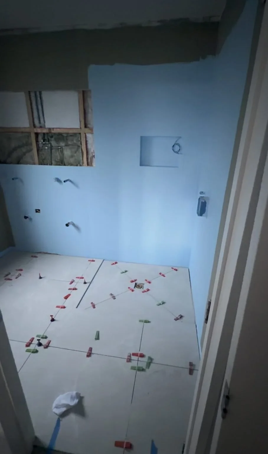 Blue waterproofing membrane applied to the walls of the Greenhithe master bathroom before tiling