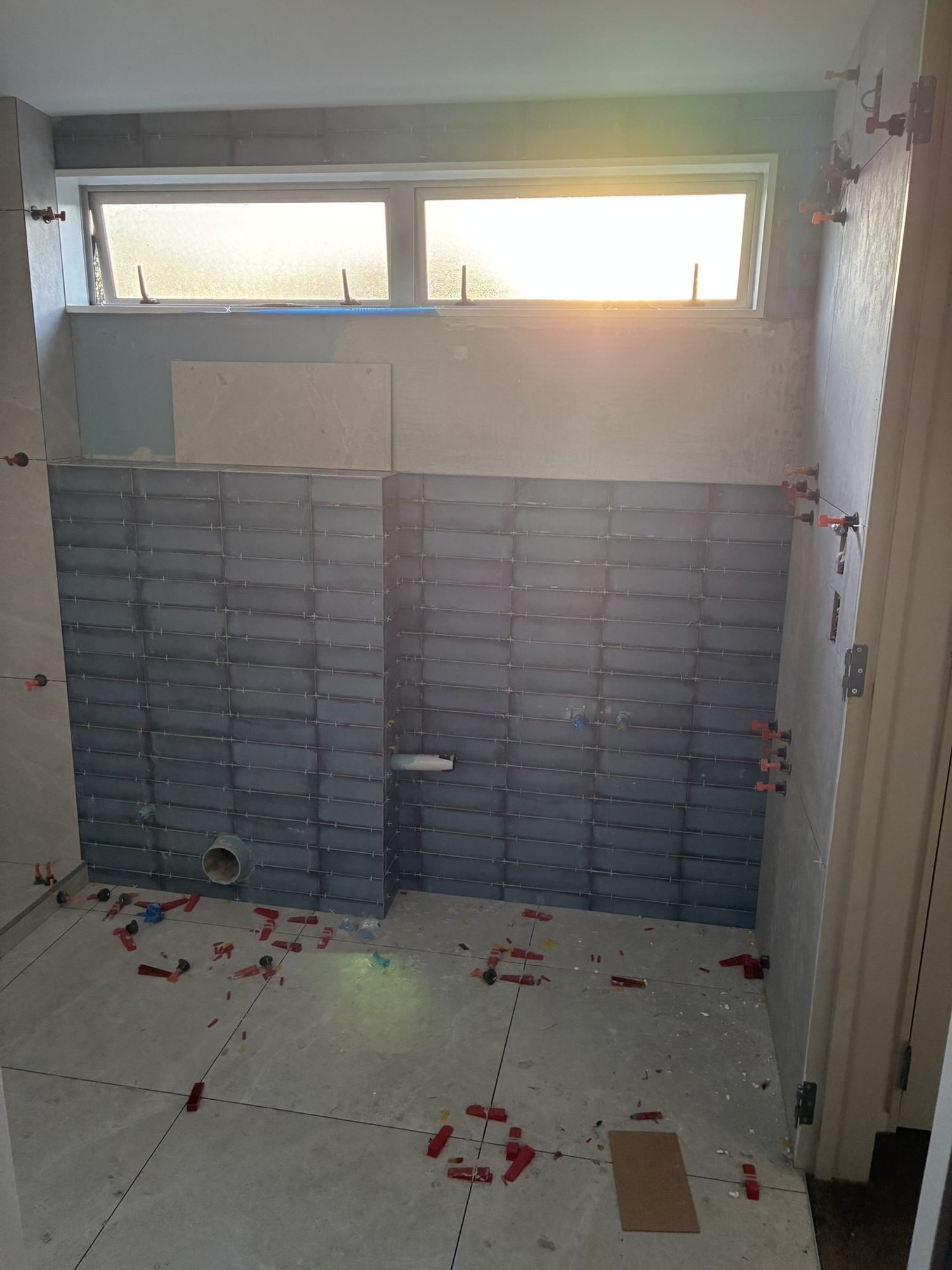 Blue gloss tile going up in the Sandringham master ensuite, spacers on the floor