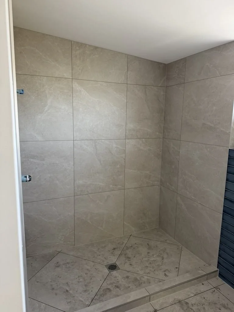 Finished shower in large-format stone-look tile, Patterson Street master ensuite, Sandringham