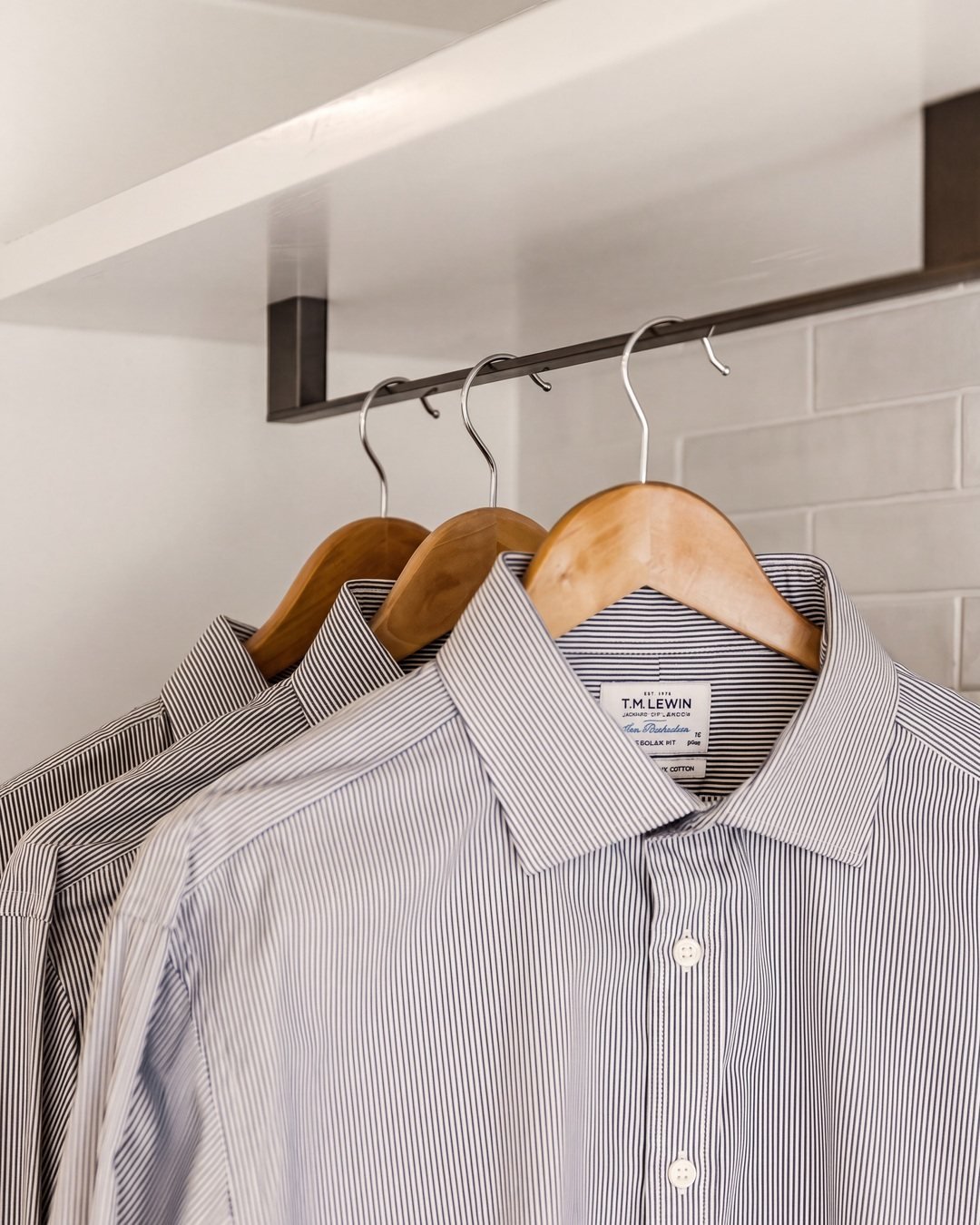 Shirts hanging on timber hangers on the blackened laundry rail, Seymour Street St Marys Bay