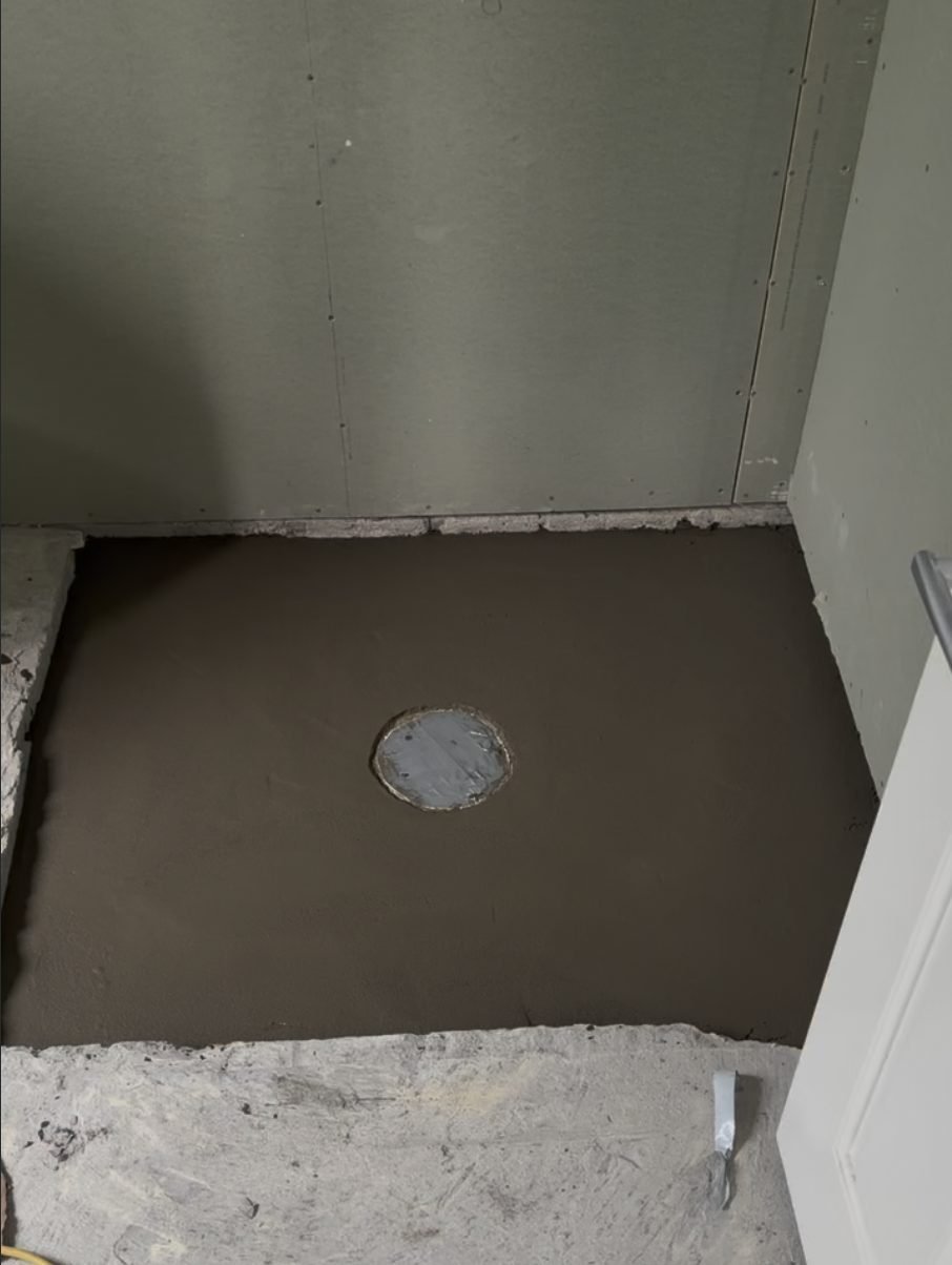 Screed bed laid to falls in the Churchouse Road bathroom floor, Greenhithe