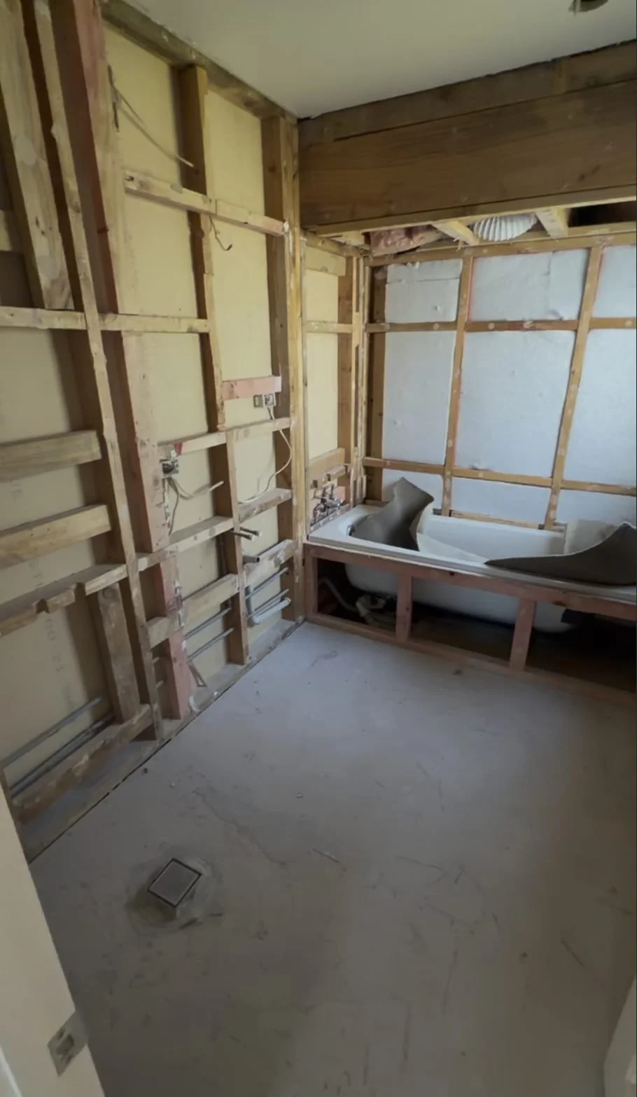 Greenhithe family bathroom stripped back to bare timber framing, with the old bath still sitting in the room