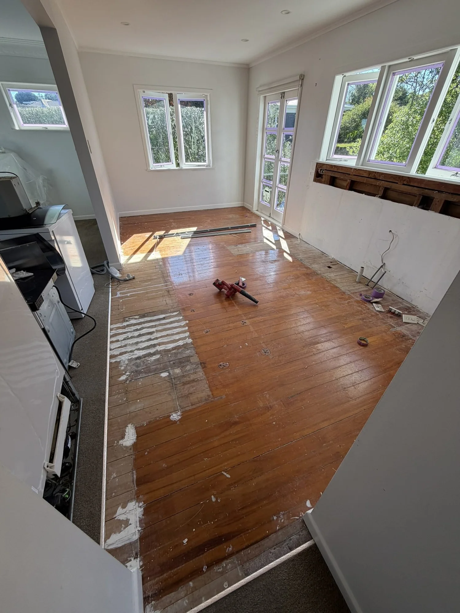 Belmont kitchen stripped bare during demolition with the timber floor exposed and protected