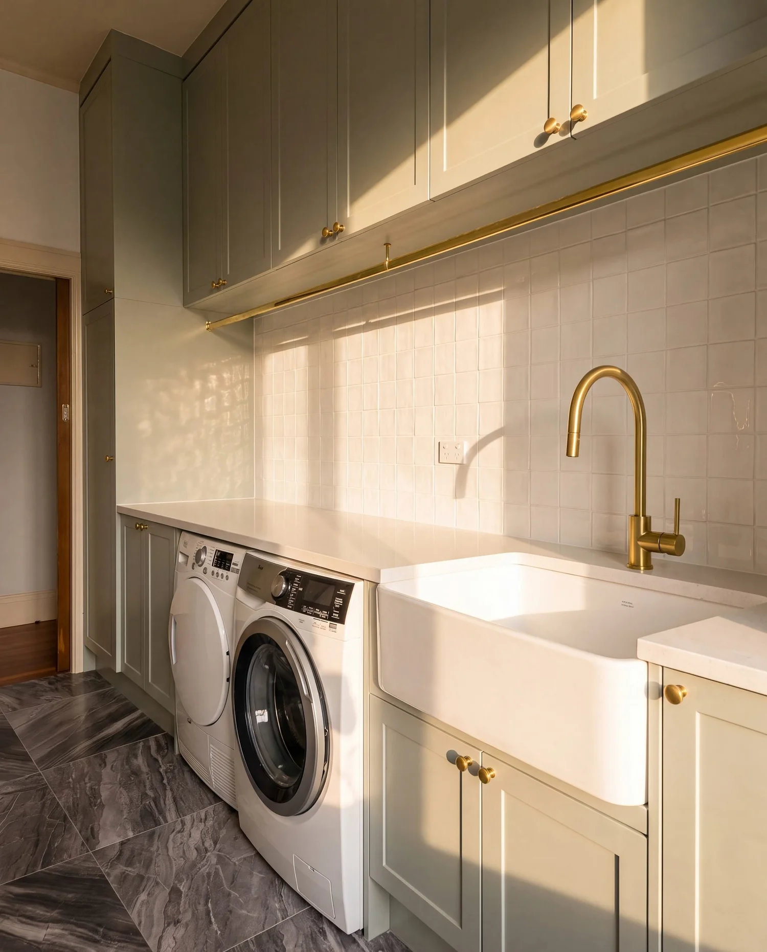 Finished Bayswater laundry with the original dark marble-look tiled floor retained