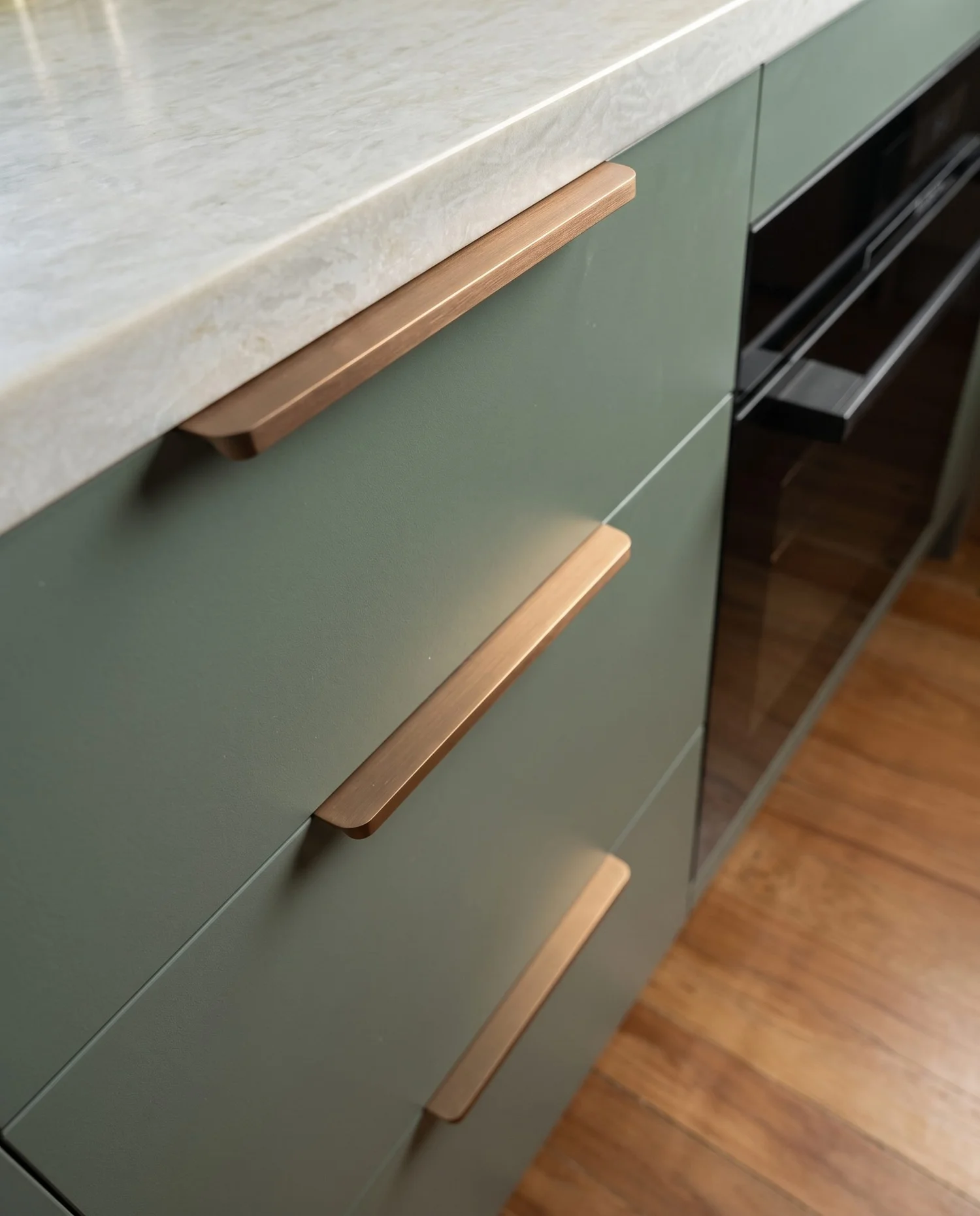 Sage green cabinetry with a bar pull handle and stone benchtop edge, Belmont kitchen renovation