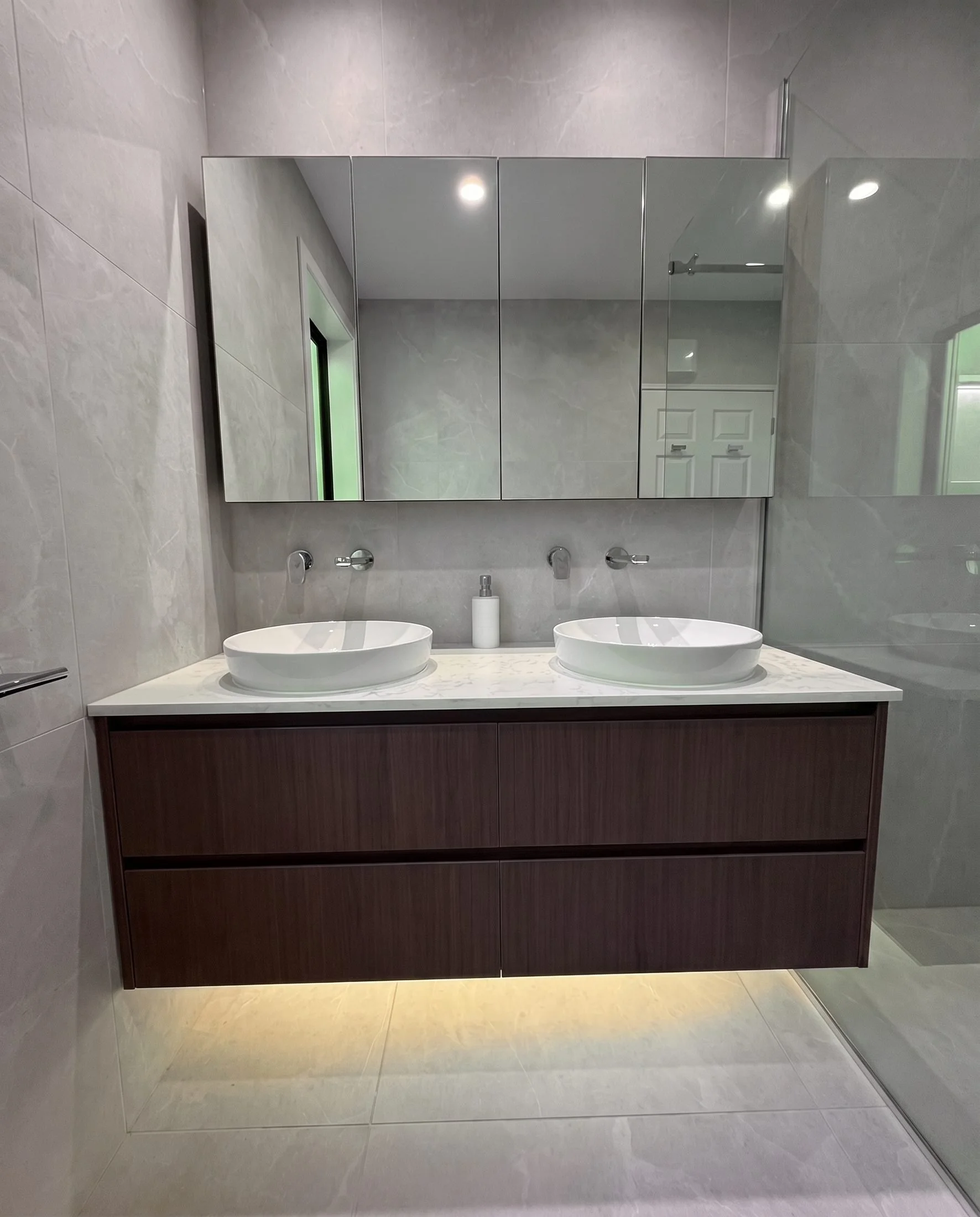 Master bathroom renovation in Greenhithe, Auckland: Churchouse Road bathroom with large-format porcelain, walnut double vanity and twin vessel basins