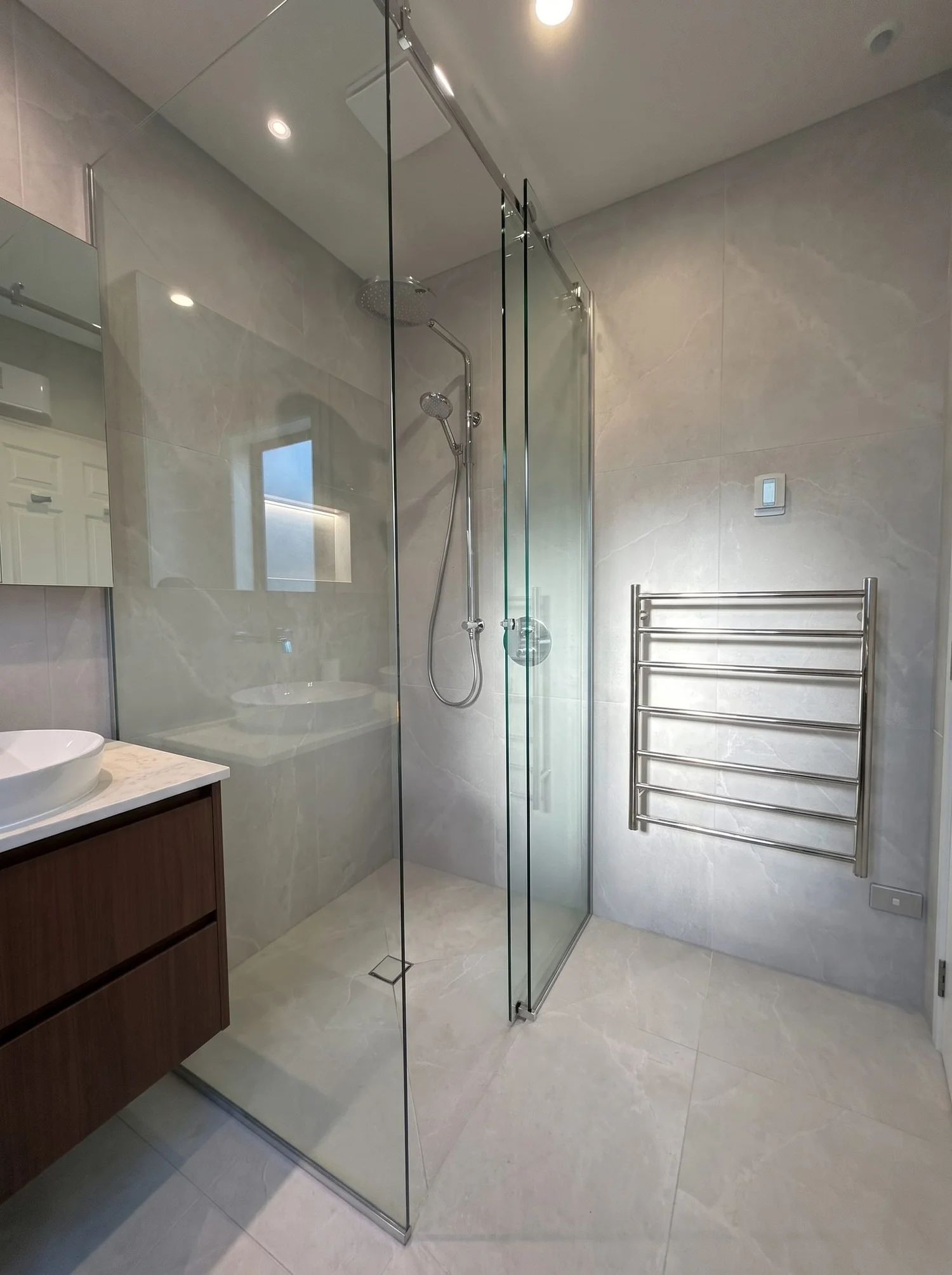 Frameless glass shower and heated towel rail in the Churchouse Road master bathroom, Greenhithe