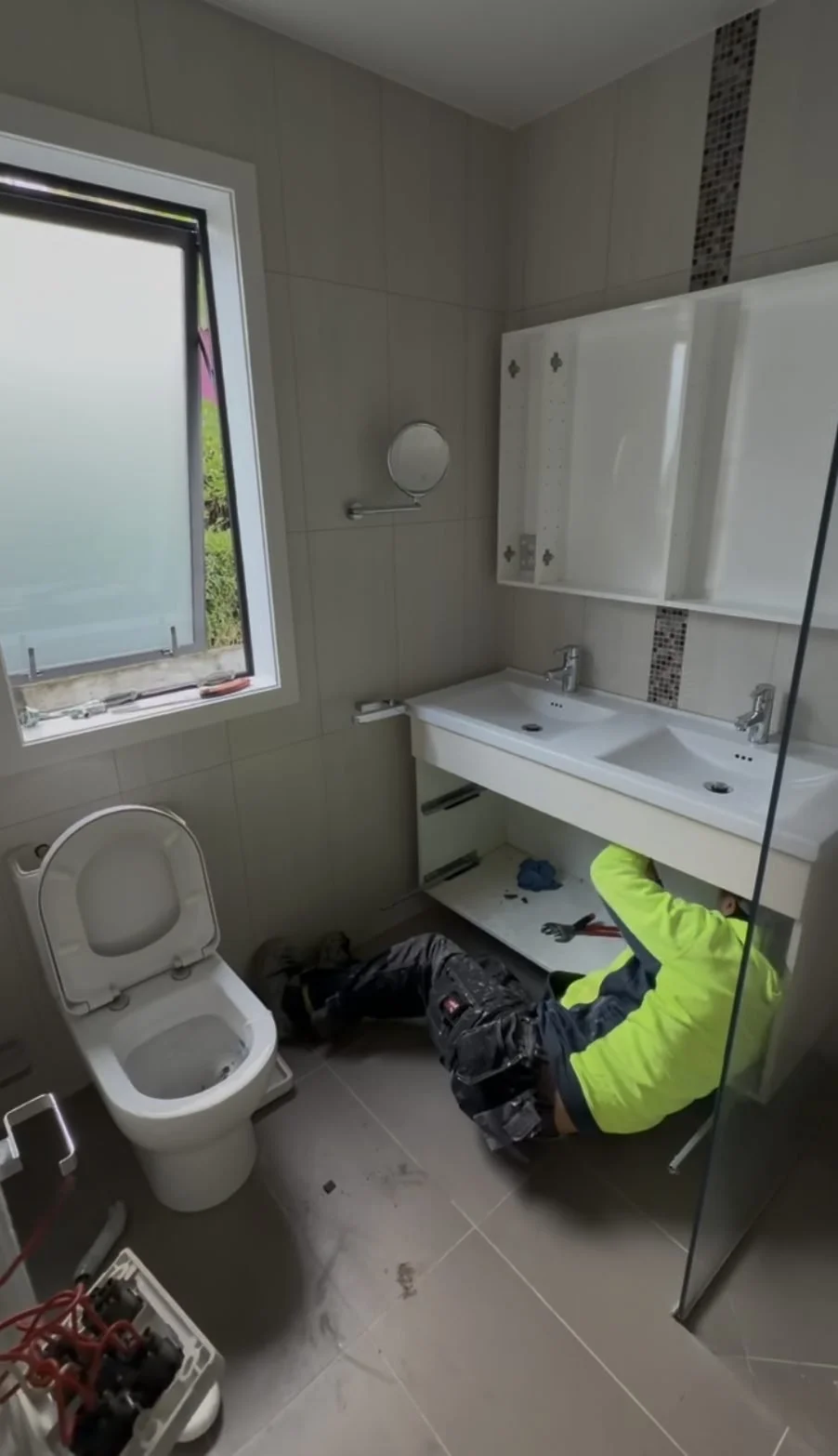 The old Greenhithe master bathroom before renovation, showing the window, toilet and laminate double vanity