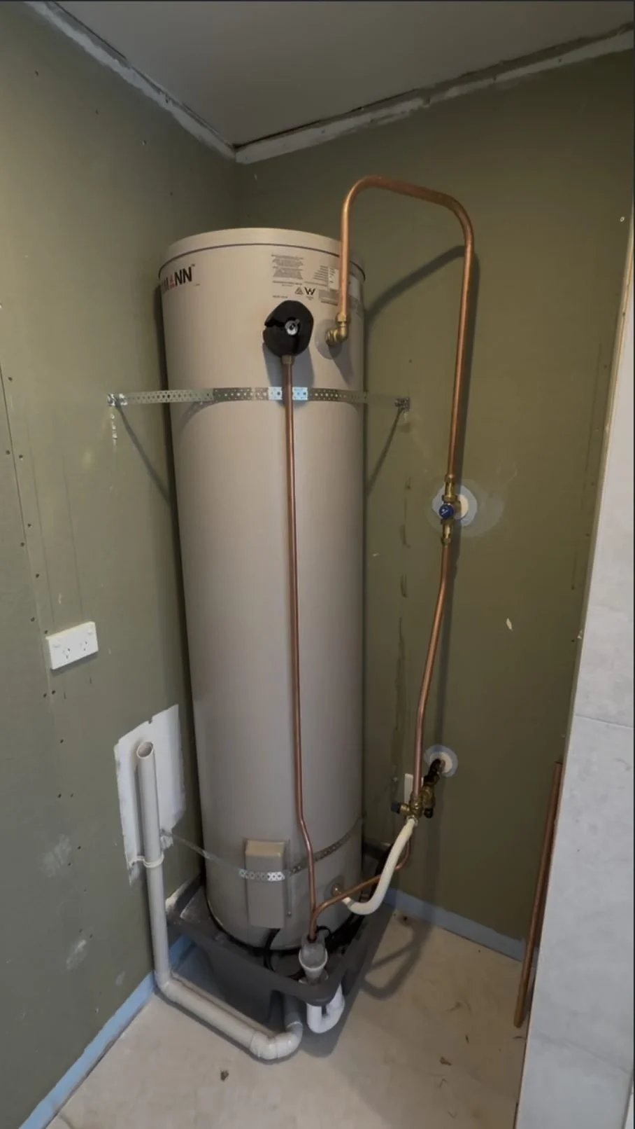 New hot water cylinder with seismic restraint straps in the Parnell laundry cupboard