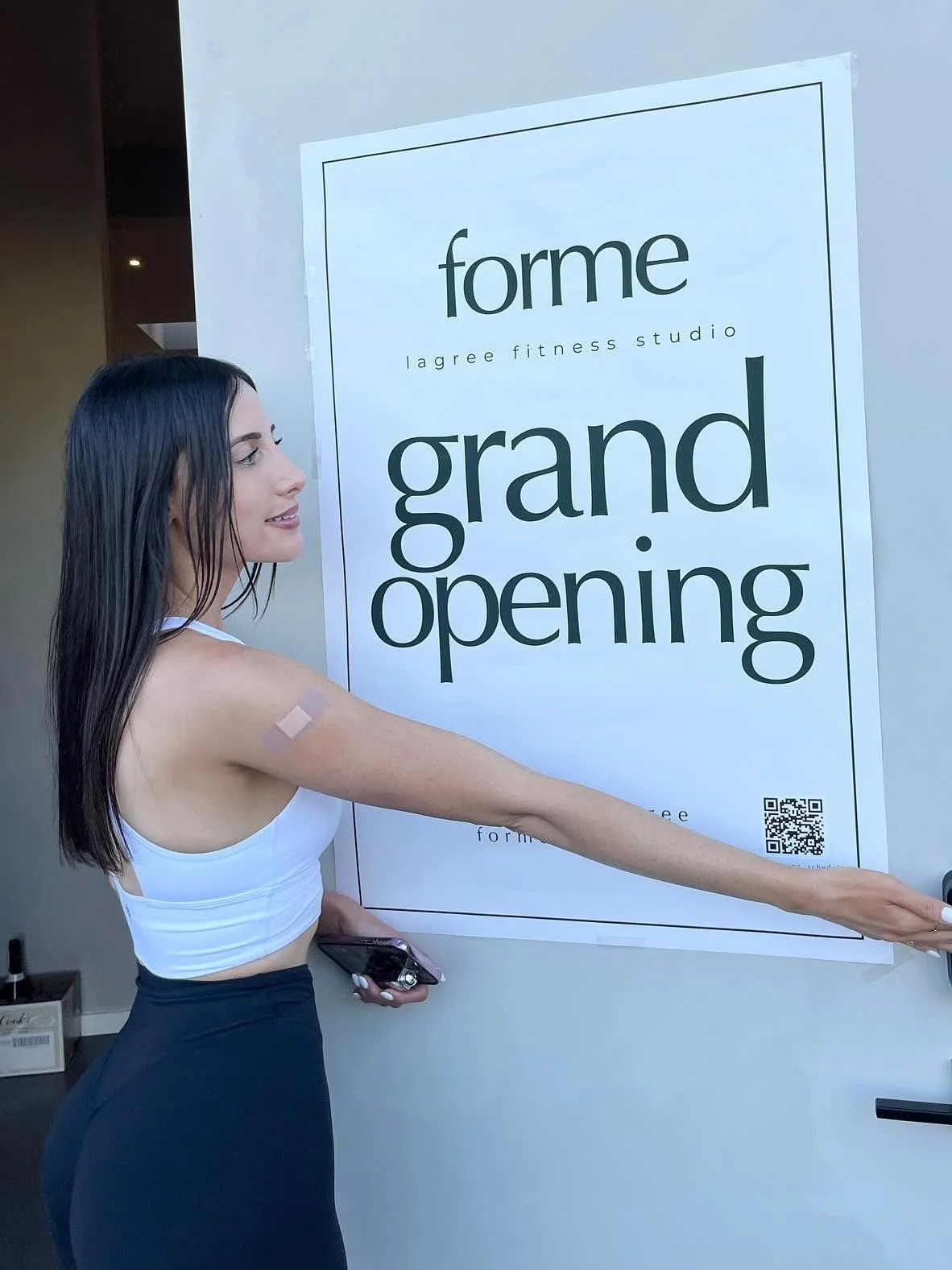 Hanging the grand opening sign on the studio door