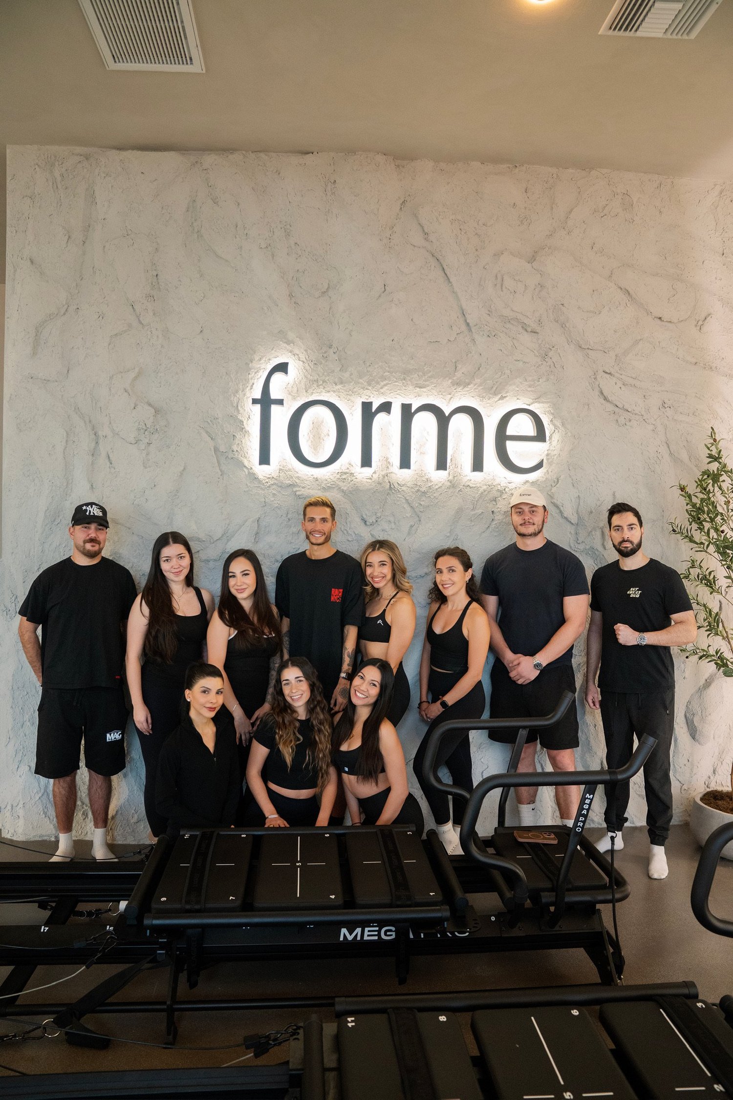 The past Forme Lagree certification cohort together in the studio