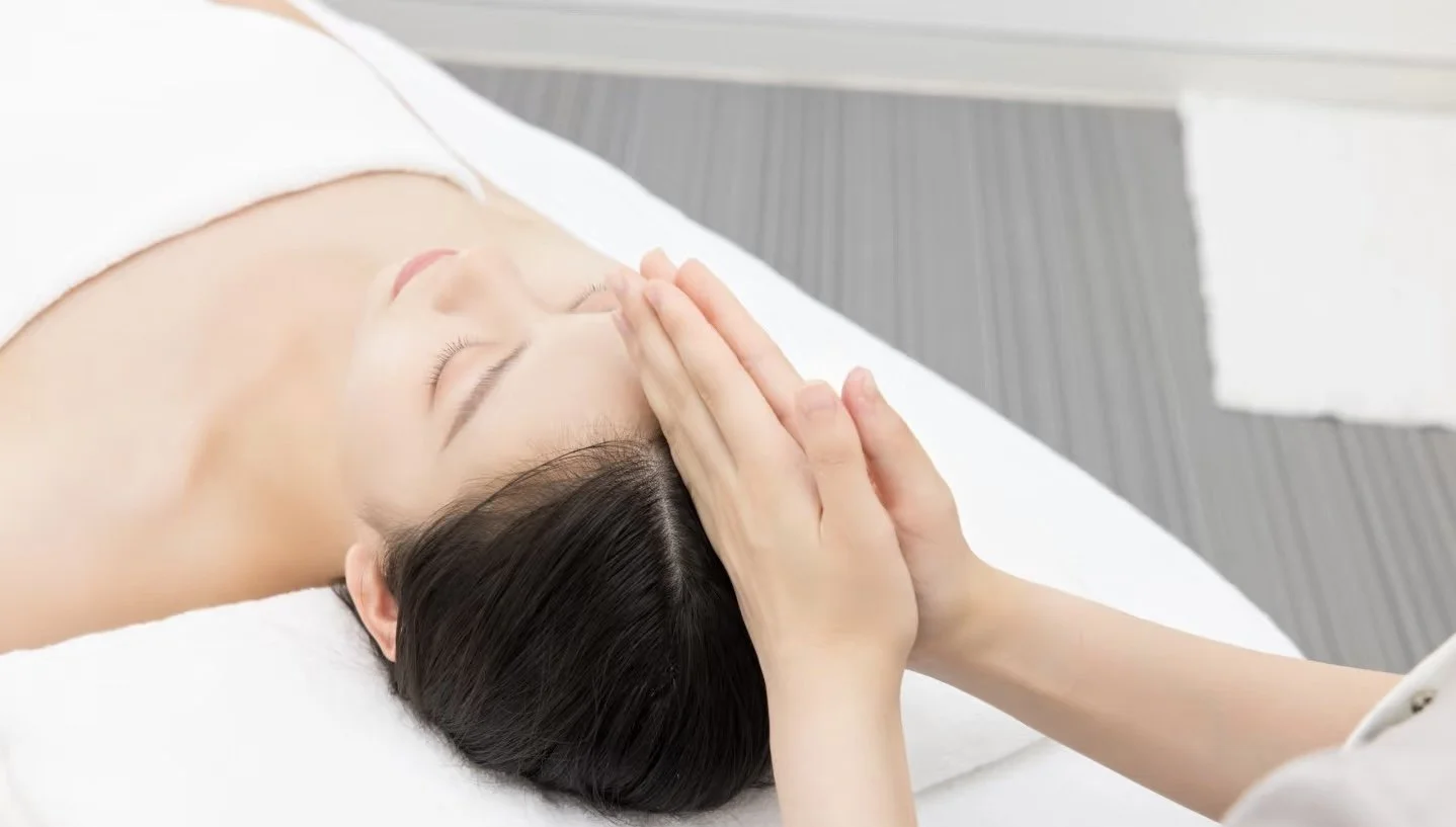 Hands gently massaging the scalp