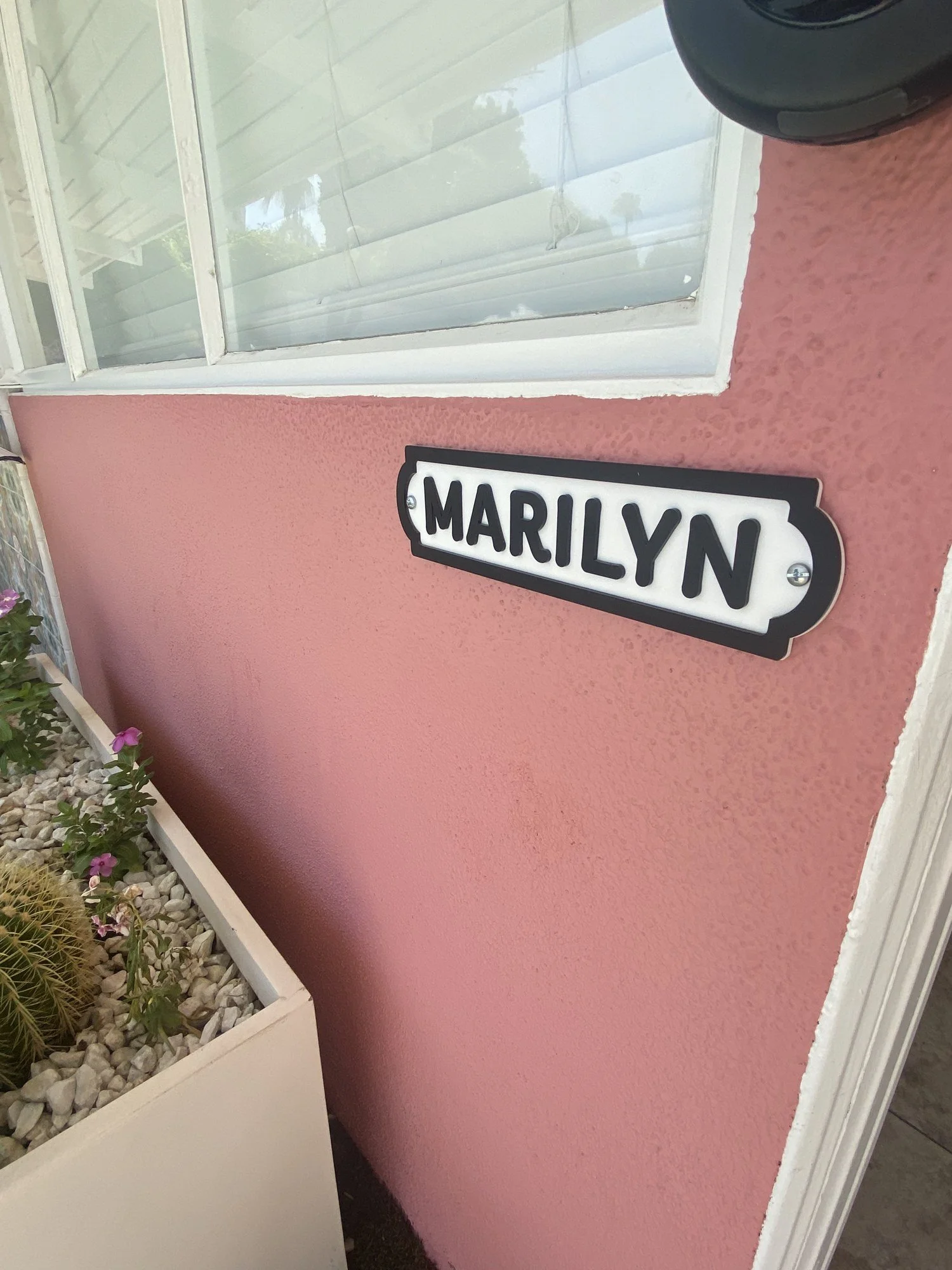 The Marilyn room plaque on a pink wall