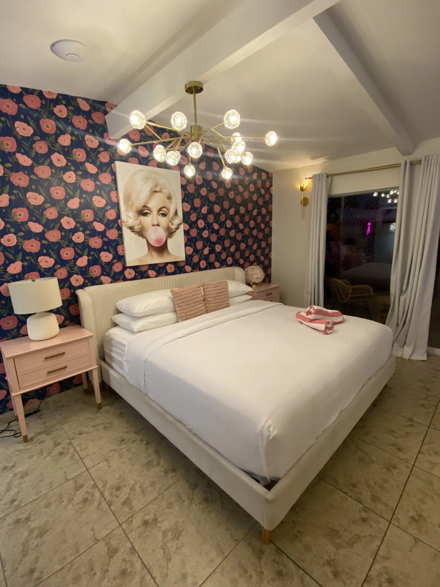 The Marilyn Suite with poppy wallpaper and a gold chandelier