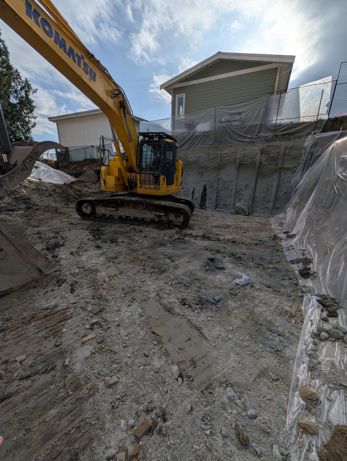 Excavator working inside the shored excavation for the underground parkade