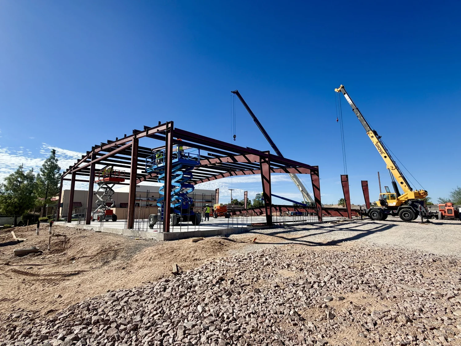 Steel framing and cranes during commercial property construction