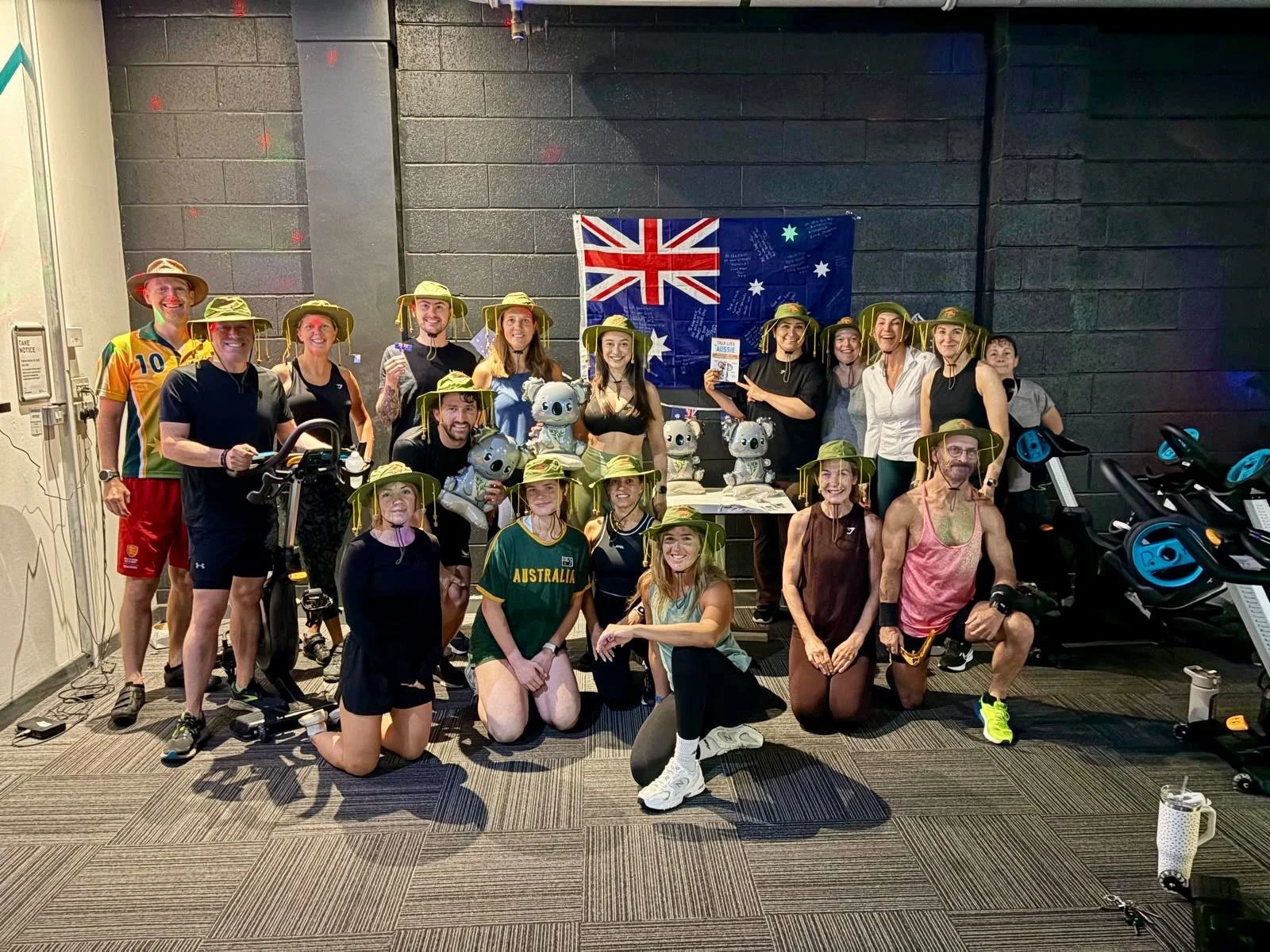 Class members posing in themed outfits beside an Australian flag