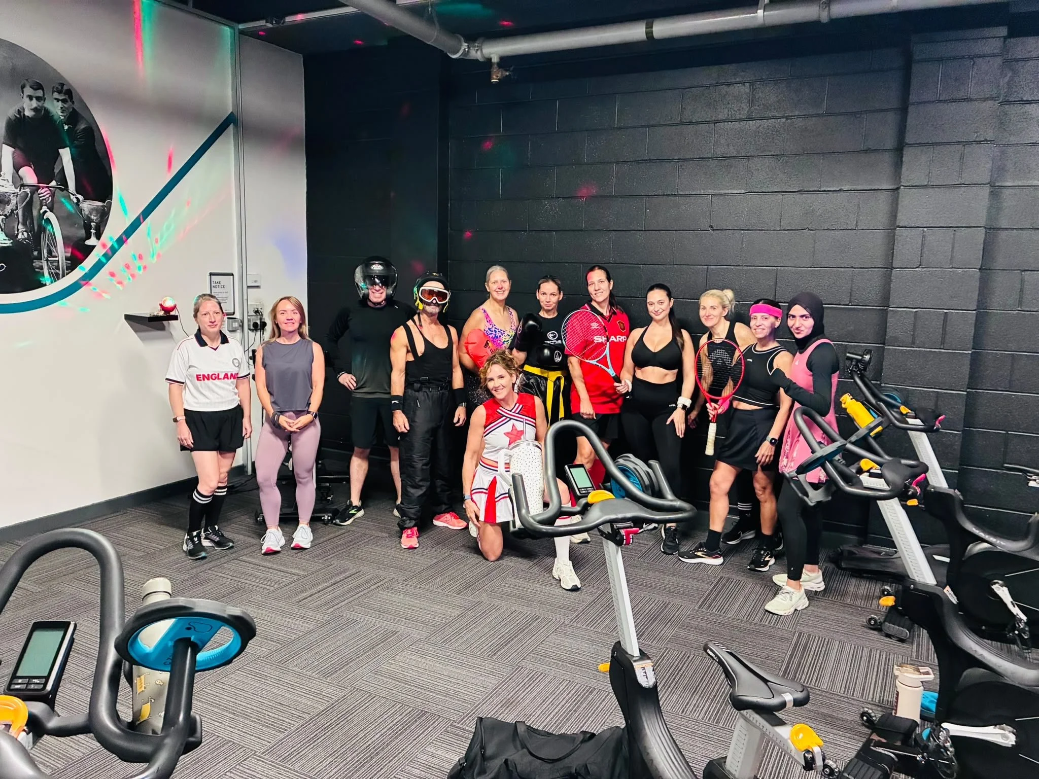 The class group posing in themed outfits in the studio