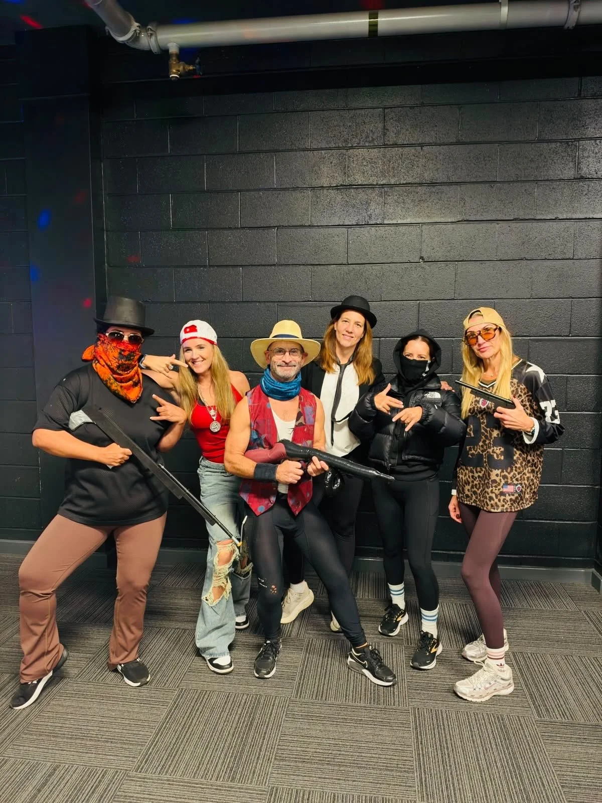 A small group in themed outfits at the spin class