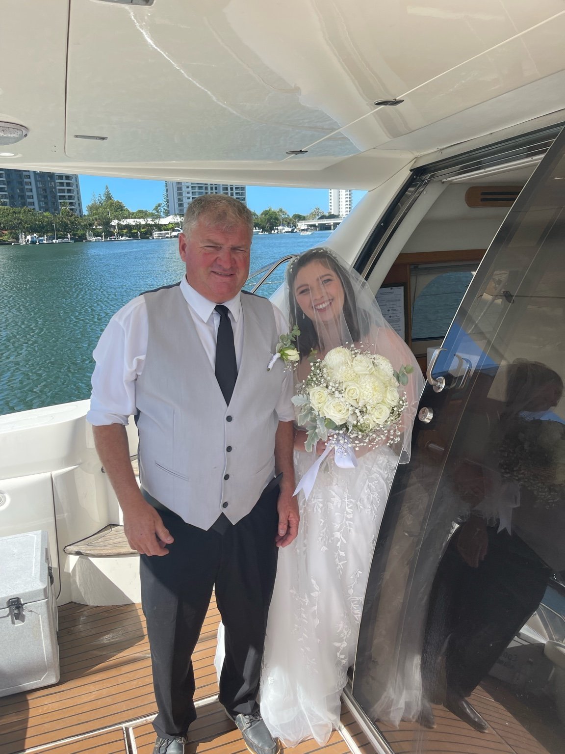 Bride walking down the aisle on a private yacht with her father