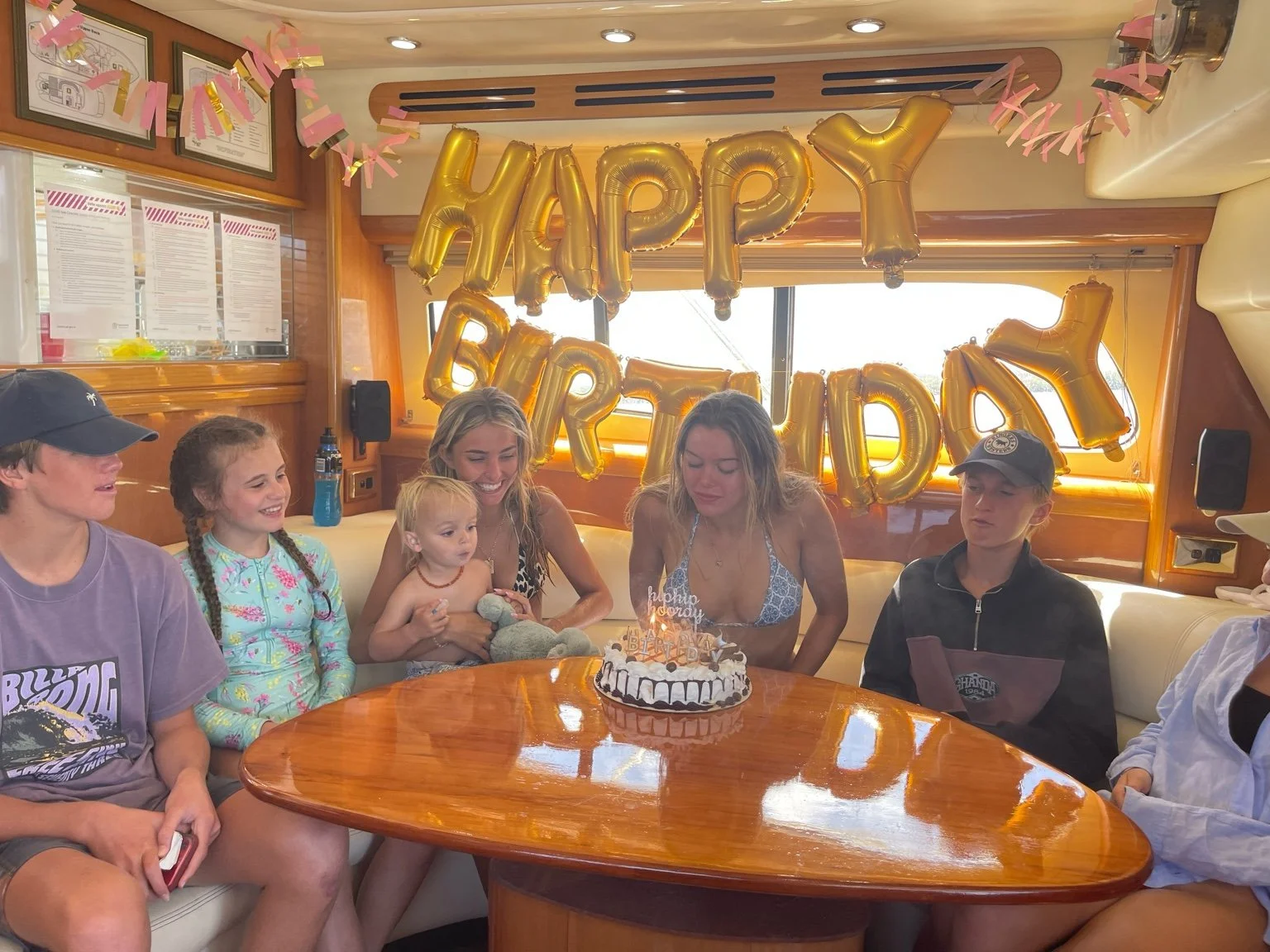 Friends toasting during a birthday cruise on the Gold Coast