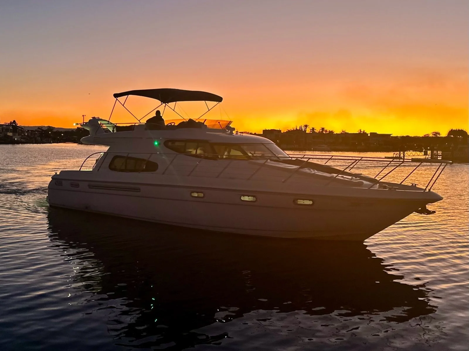 Inspiration luxury yacht silhouetted against a Gold Coast sunset