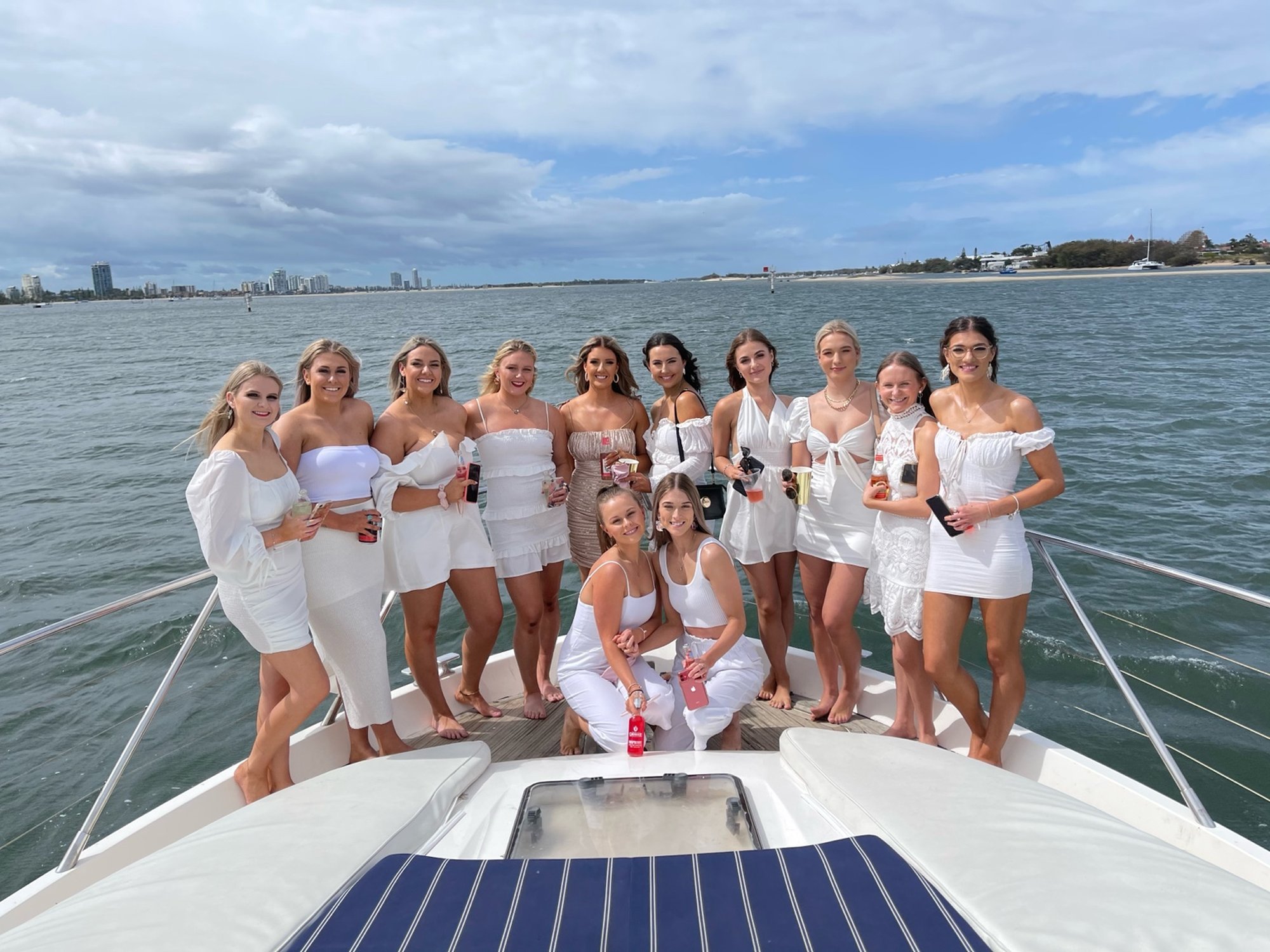 Hens party posing on the bow in white outfits aboard Inspiration Cruises