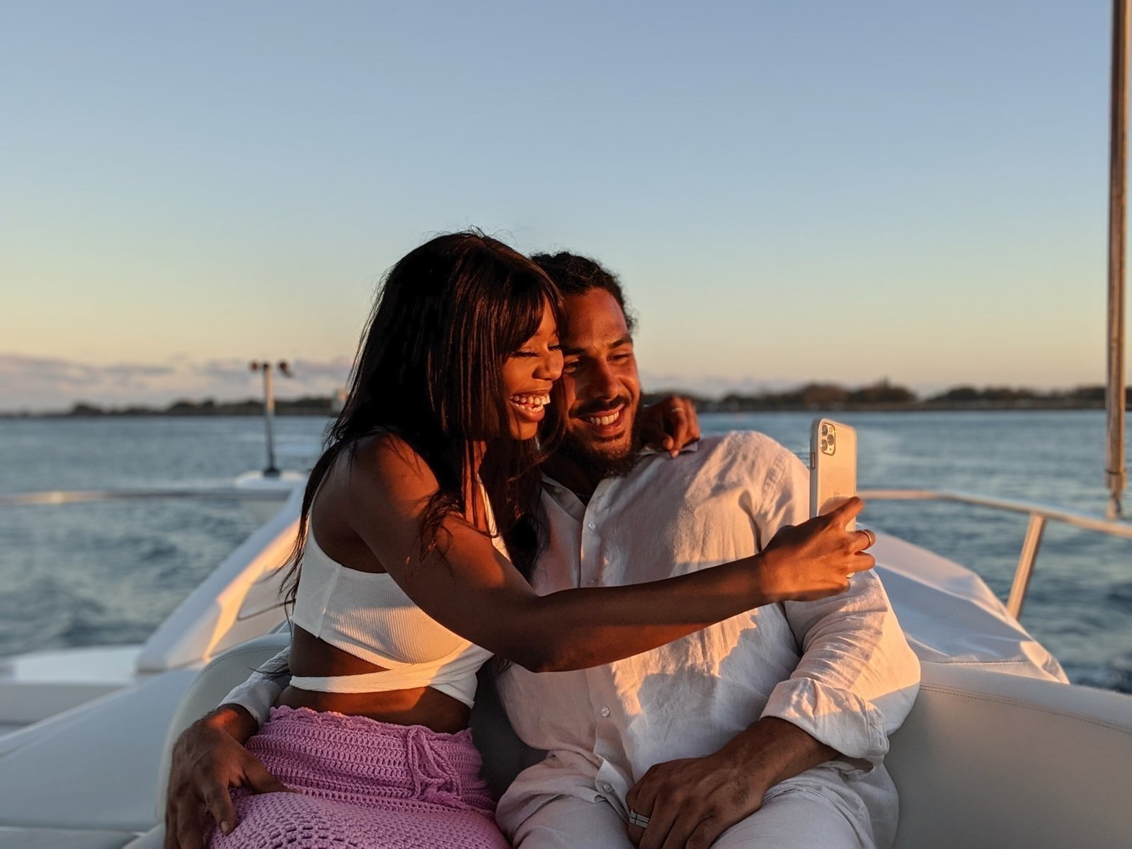 Couple taking a romantic sunset selfie on a Gold Coast cruise