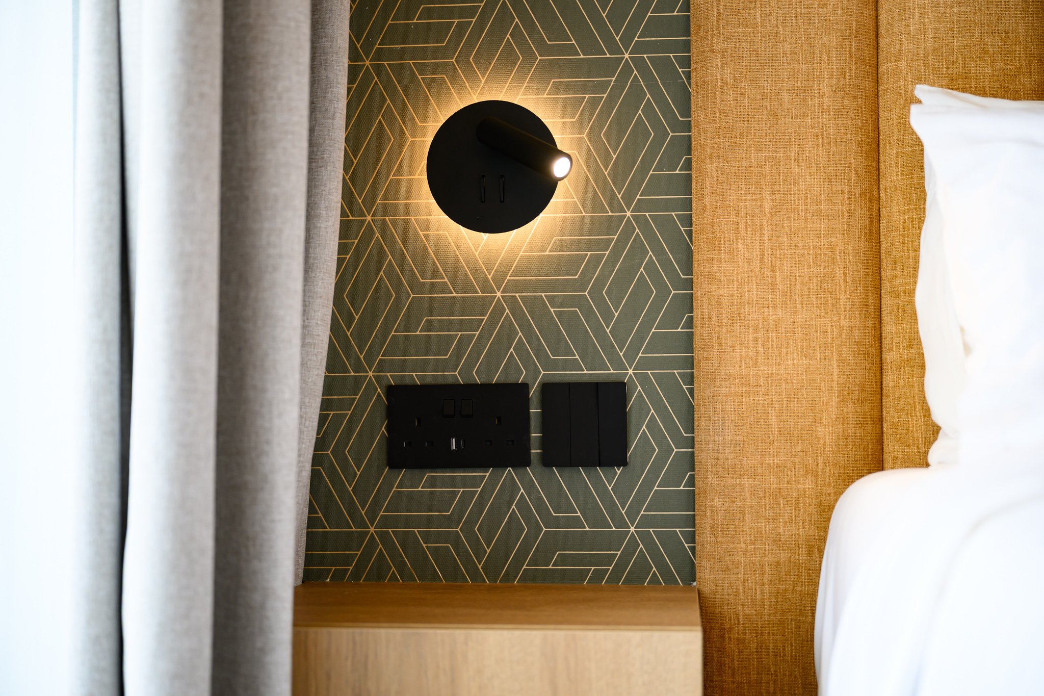 Nisia Signature Suite amenity — Bedside USB-A, USB-C and sockets