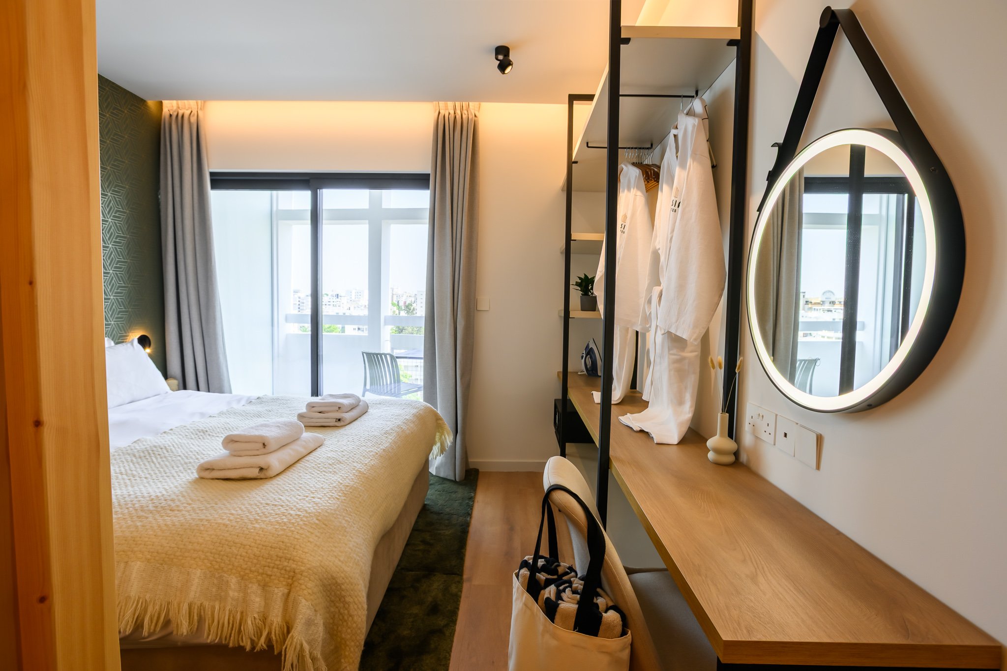 Nisia Junior Suite — Bedroom with LED vanity mirror