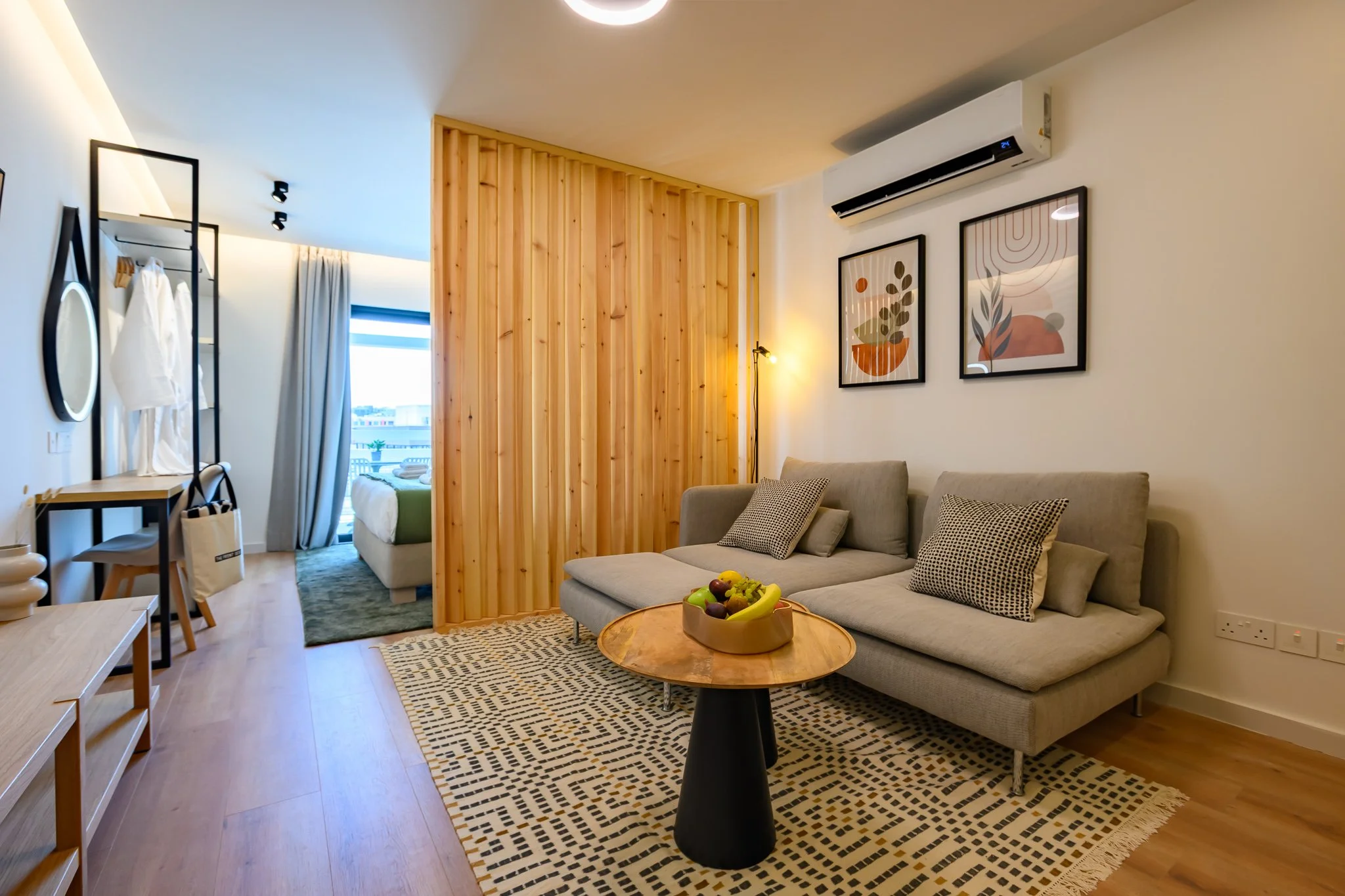 Nisia Signature Suite — Sofa lounge and timber partition
