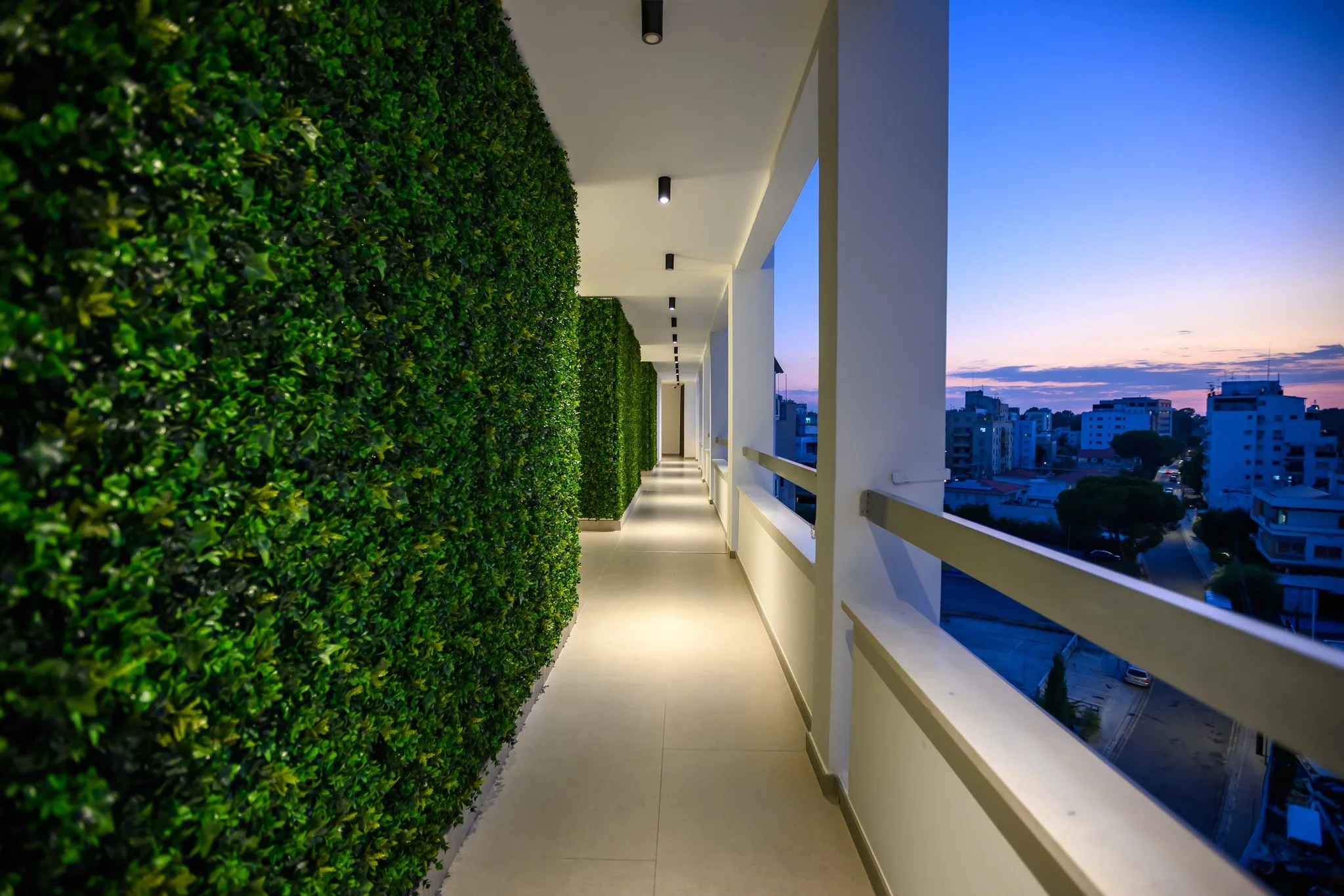 Nisia Suites building — Top-floor corridor at dusk
